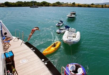 a person on a surfboard in the water aboard BLUE MOON Yacht for Charter