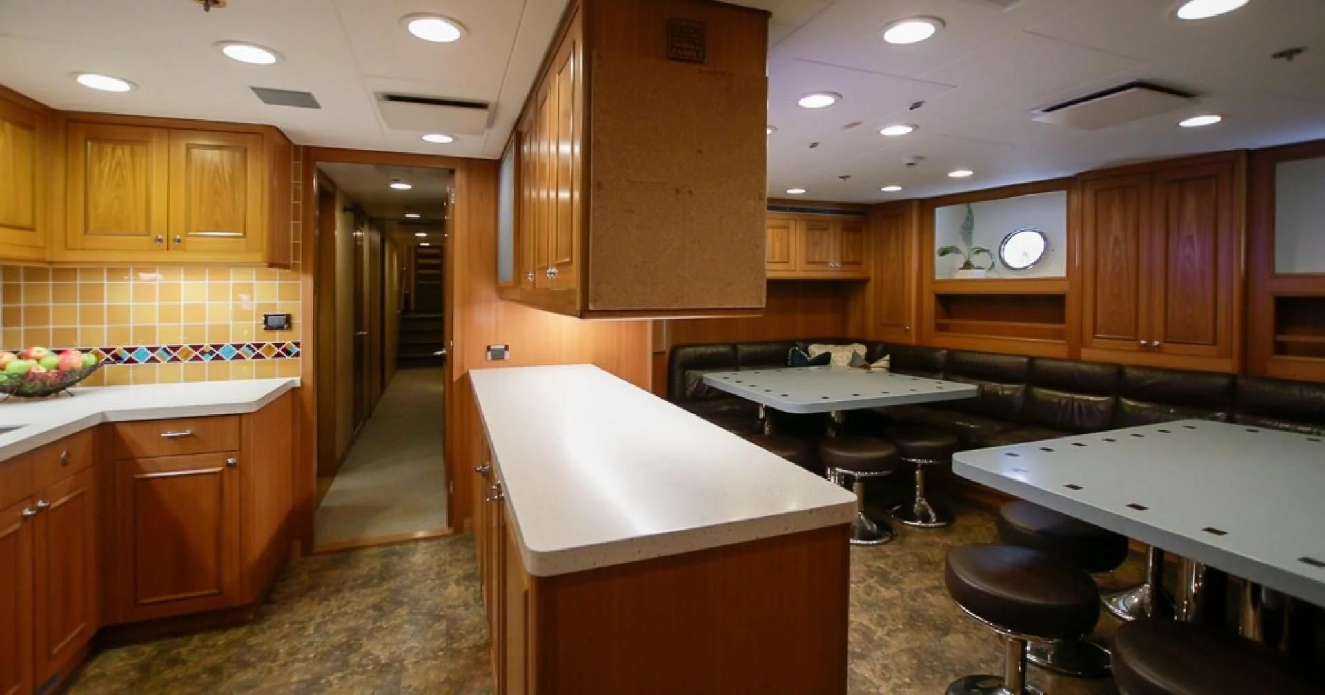 a kitchen with wooden cabinets aboard BLUE MOON Yacht for Charter