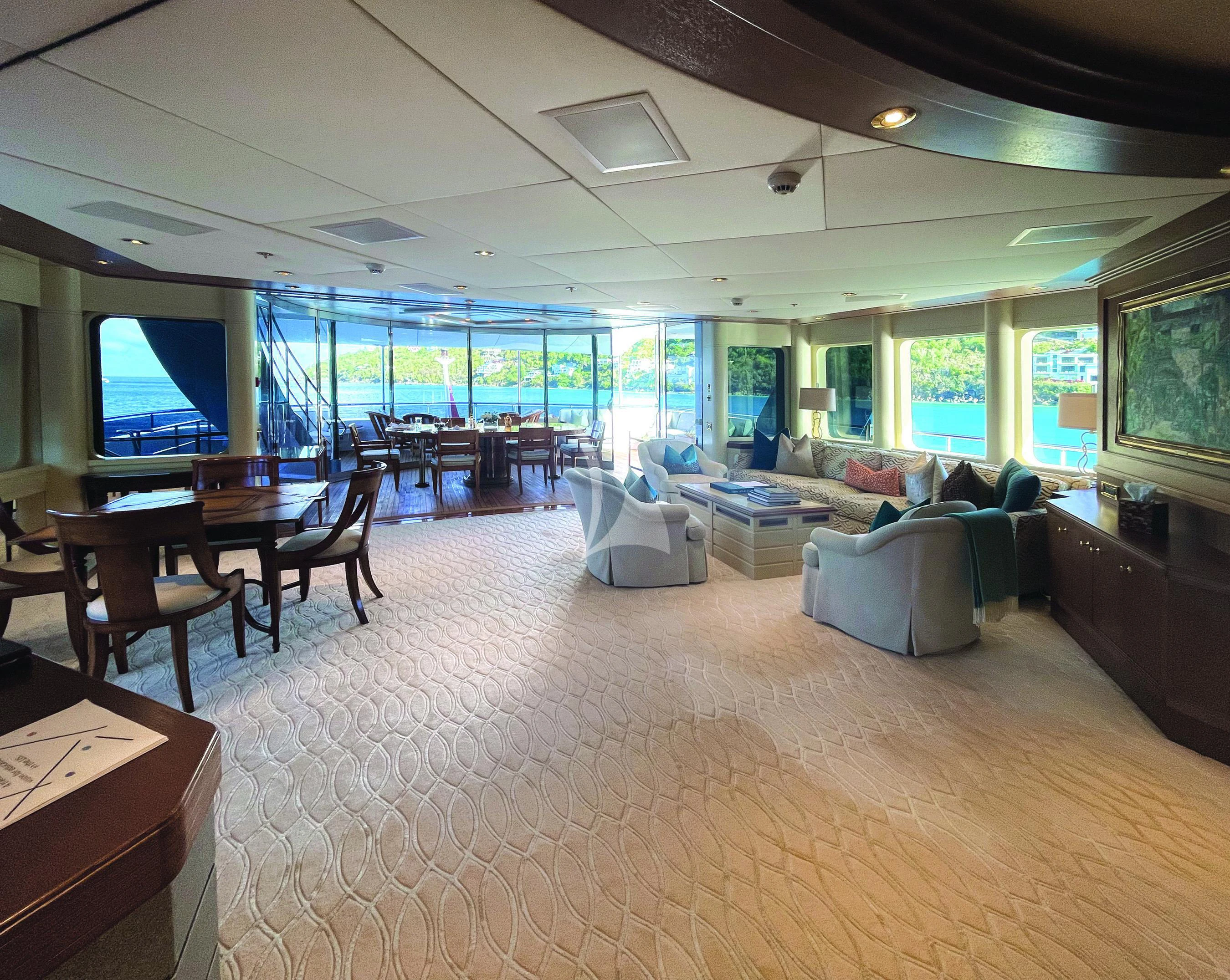 a living room with a large screen aboard BLUE MOON Yacht for Charter