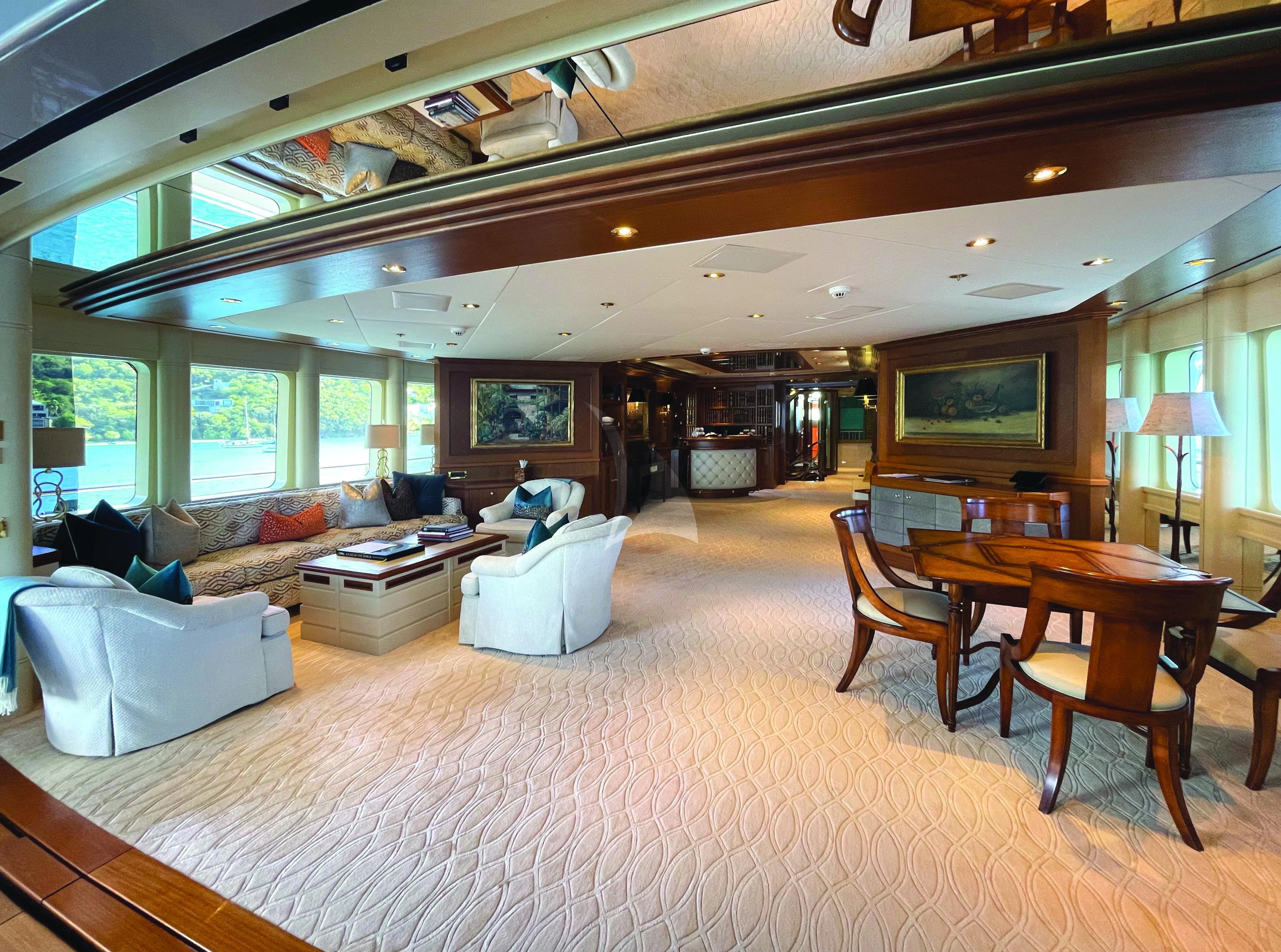 a large living room with a large bed and a large window aboard BLUE MOON Yacht for Charter