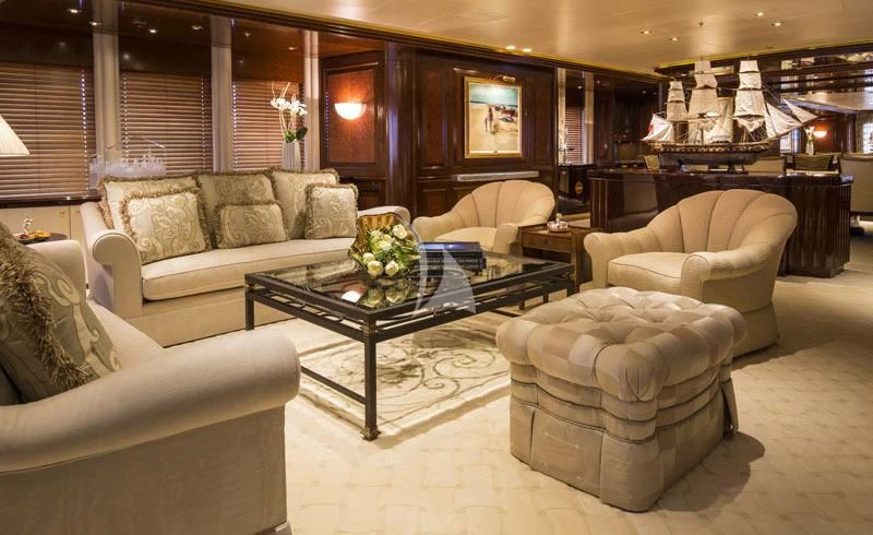 a living room with a large sofa and a coffee table aboard BLUE MOON Yacht for Charter