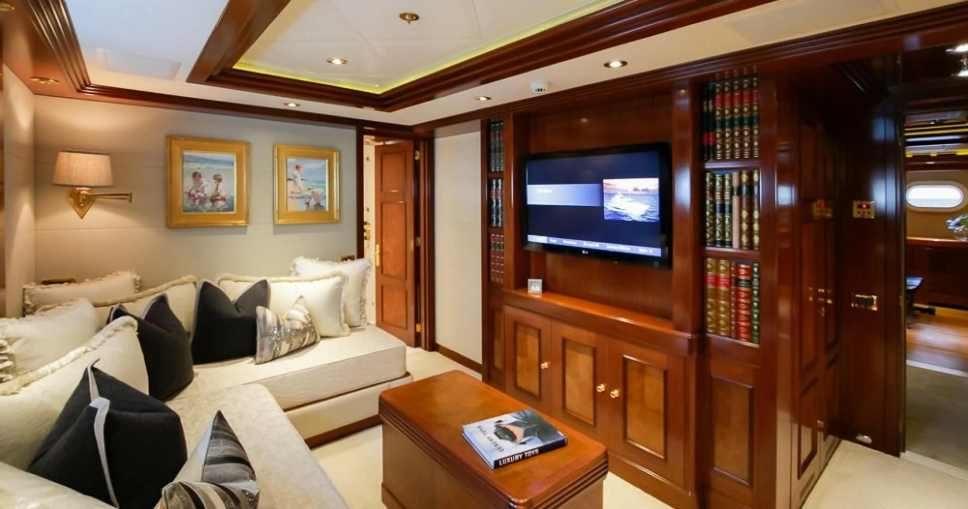 a living room with a large television aboard BLUE MOON Yacht for Charter