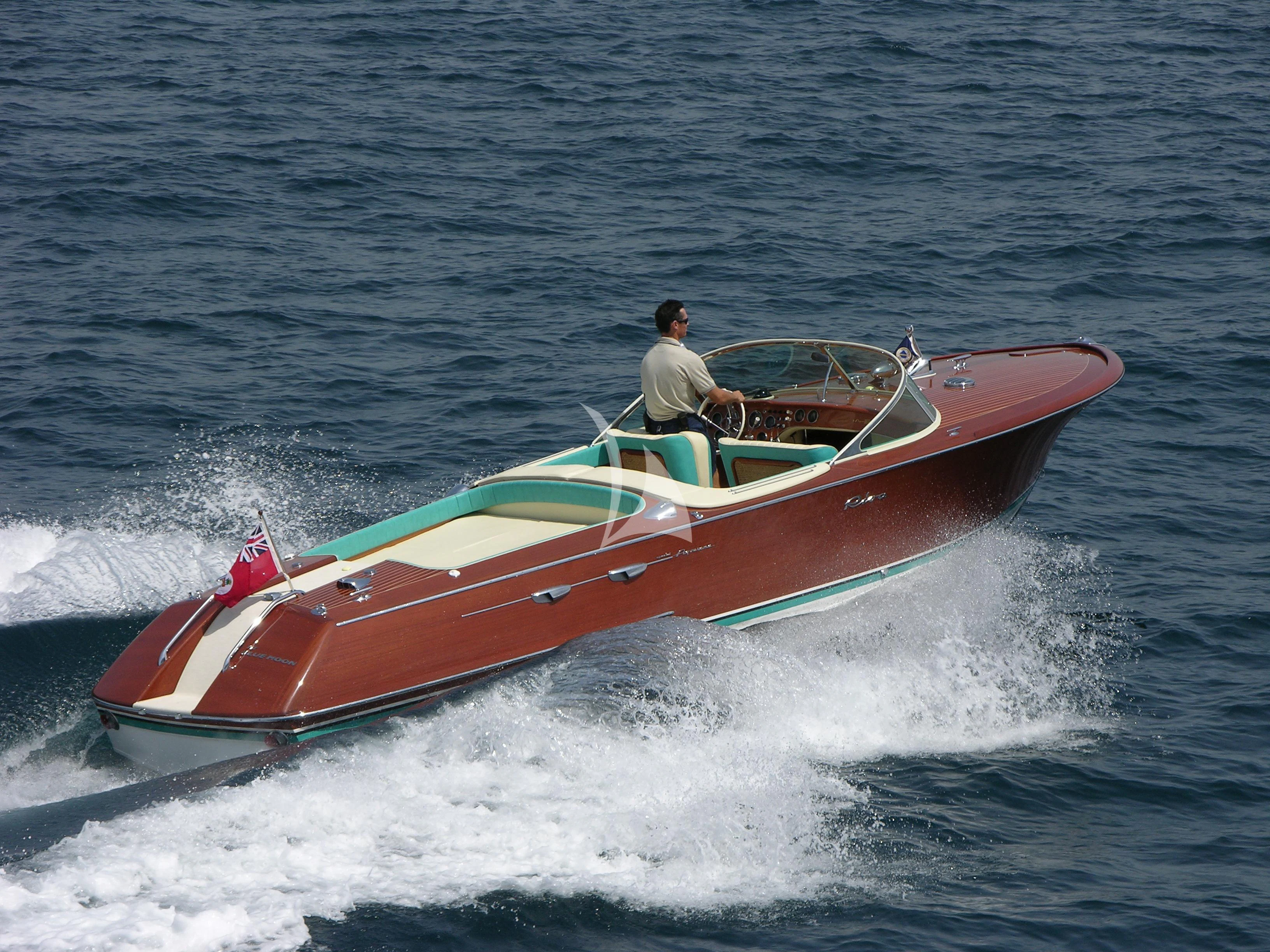 a person driving a speed boat aboard BLUE MOON Yacht for Charter