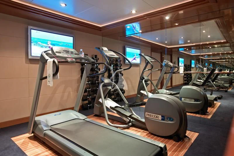 a gym with exercise equipment aboard BLUE MOON Yacht for Charter