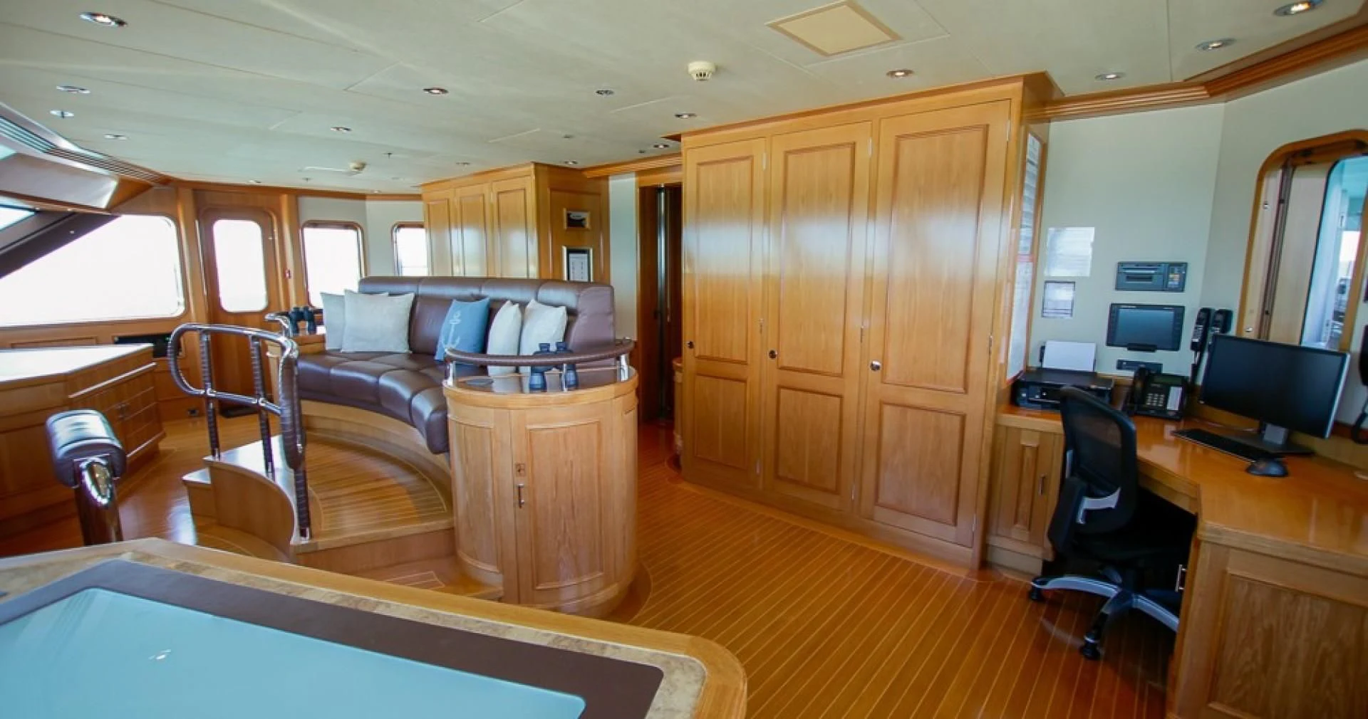 a room with a couch and a desk aboard BLUE MOON Yacht for Charter