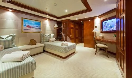 a room with a bed and a tv aboard BLUE MOON Yacht for Charter
