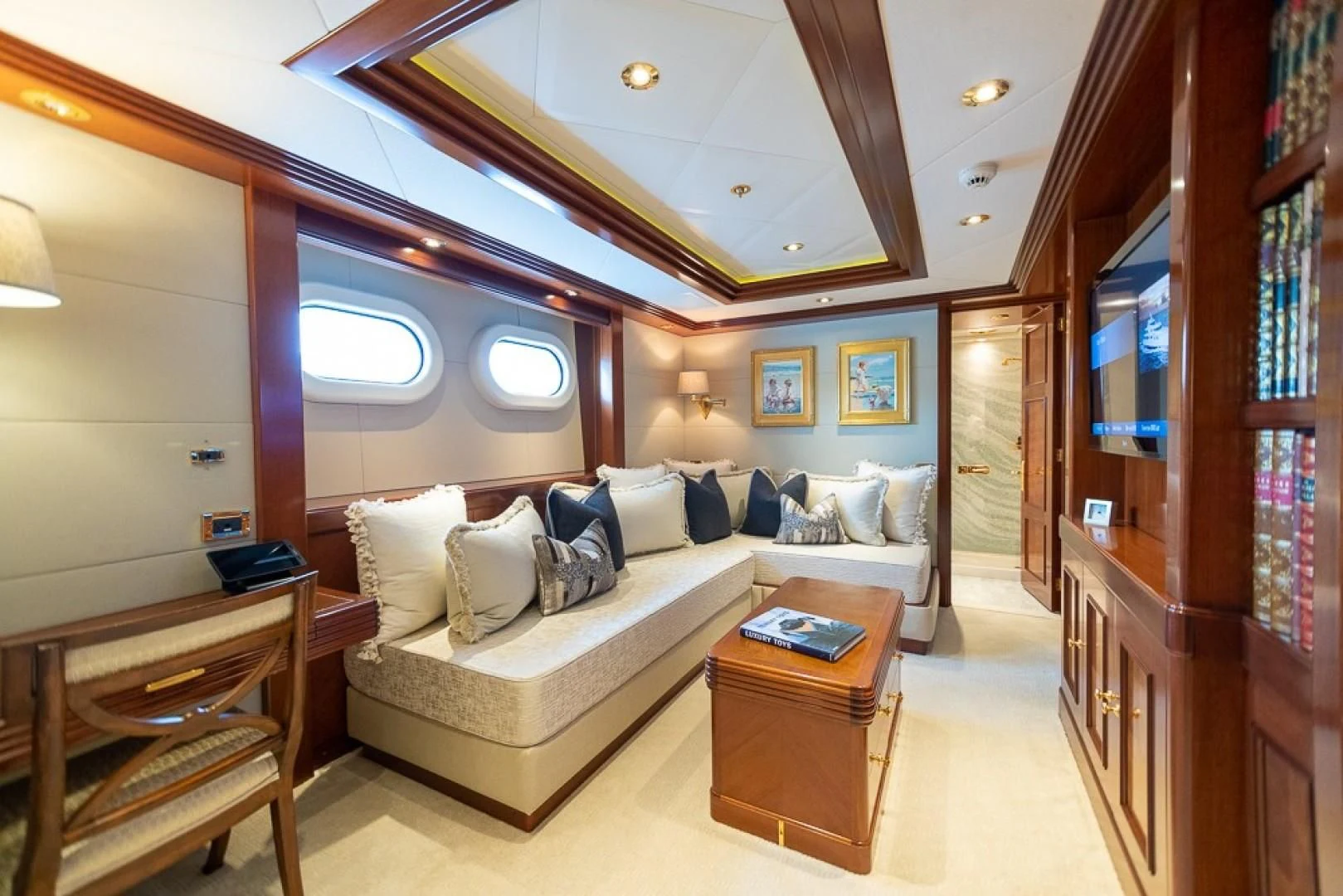 a living room with a couch and a table aboard BLUE MOON Yacht for Charter