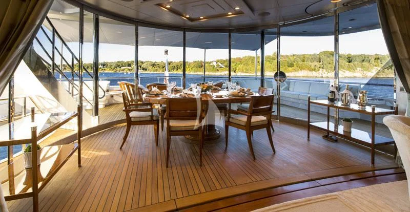 a room with a table and chairs aboard BLUE MOON Yacht for Charter