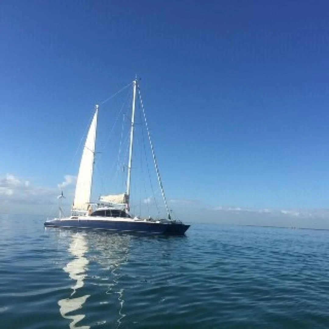 a sailboat in the water aboard BLUE MOON Yacht for Charter