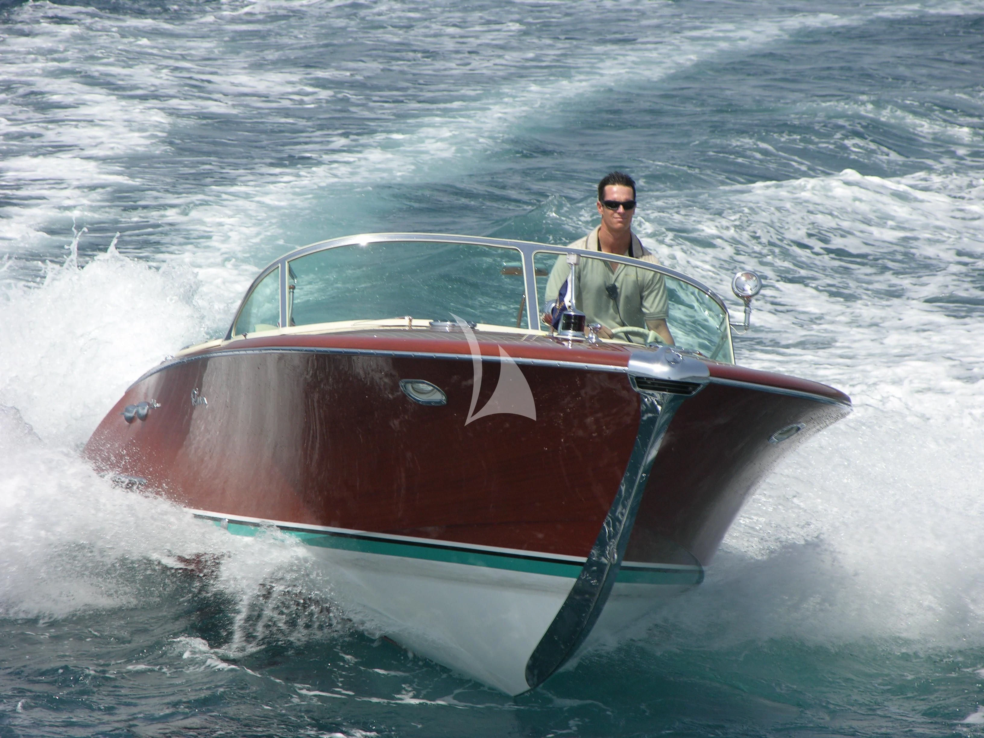 a man in a speedboat aboard BLUE MOON Yacht for Charter