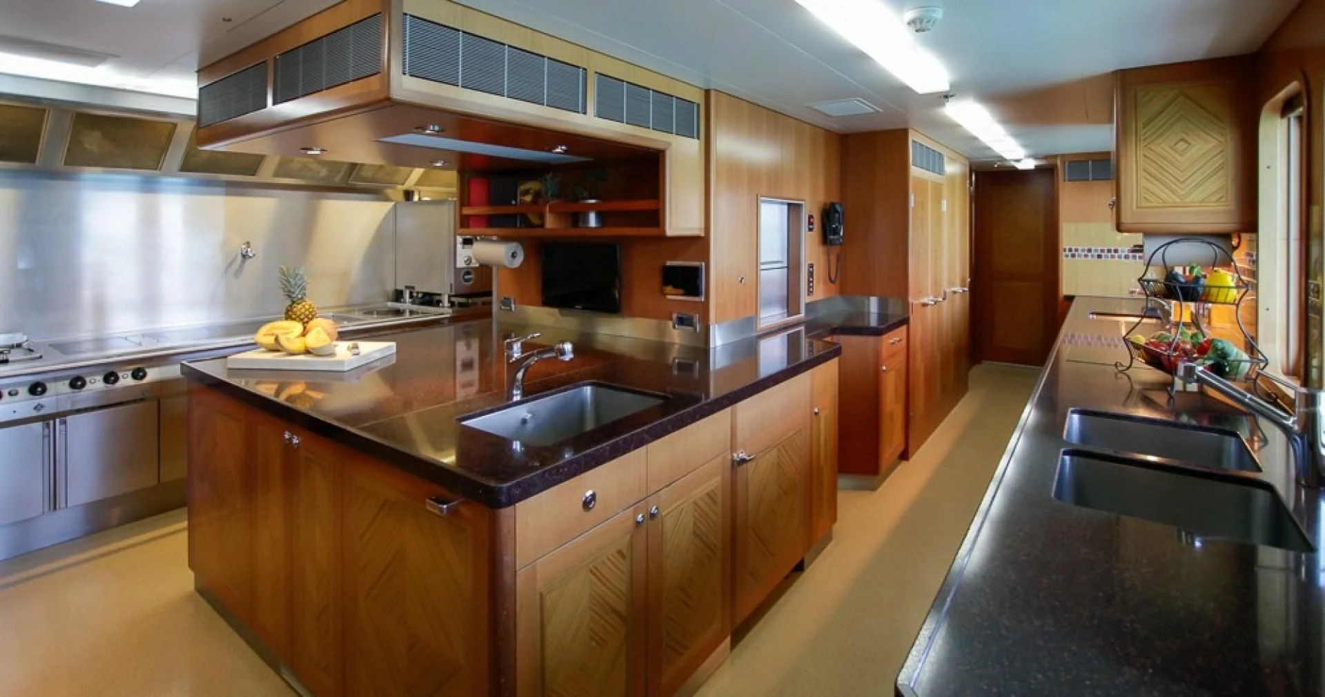 a kitchen with a black counter aboard BLUE MOON Yacht for Charter