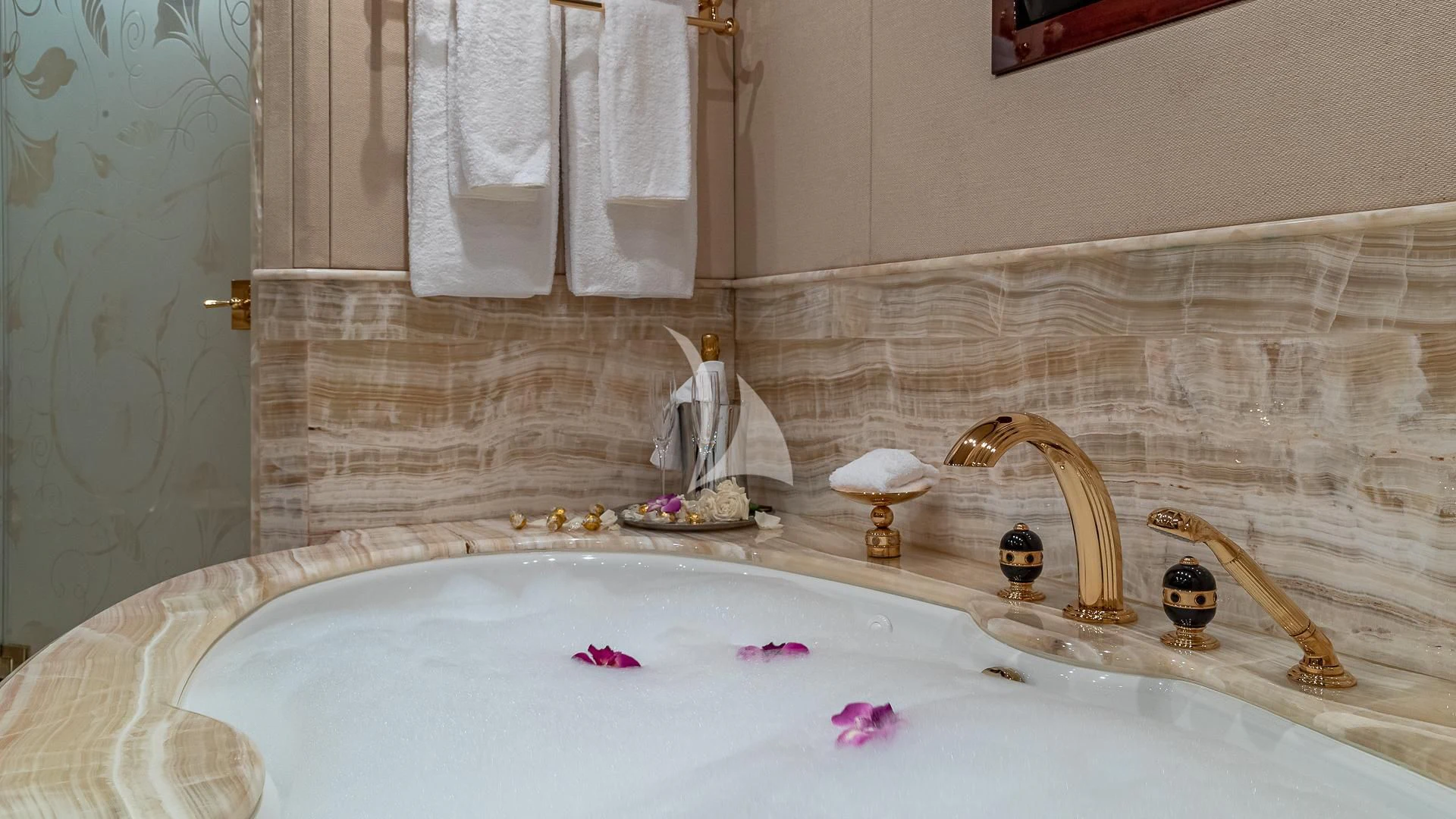 a bathtub with a sink and a mirror aboard LADY ELAINE Yacht for Charter