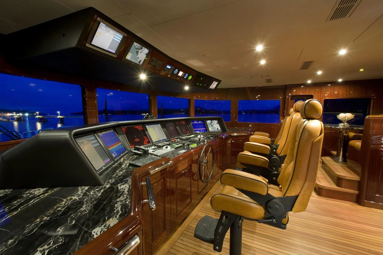 a room with a large table and chairs with computers on the tables aboard LADY ELAINE Yacht for Charter