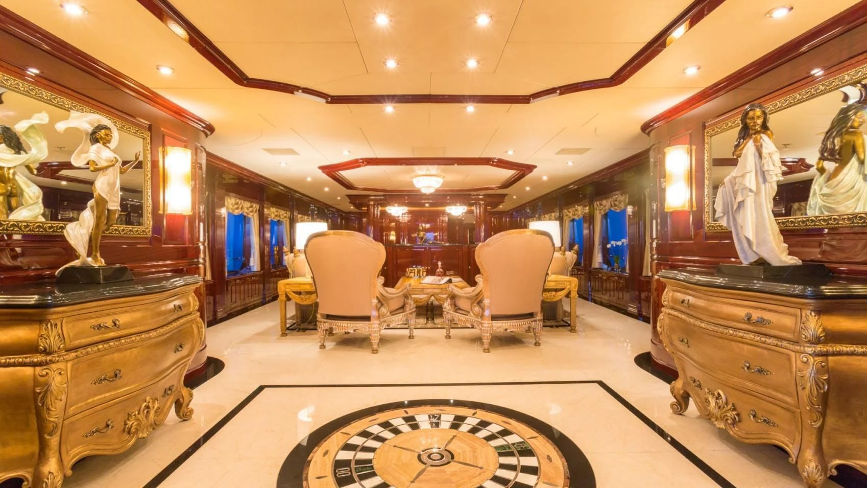a room with a large mirror and a few chairs and a table aboard LADY ELAINE Yacht for Charter