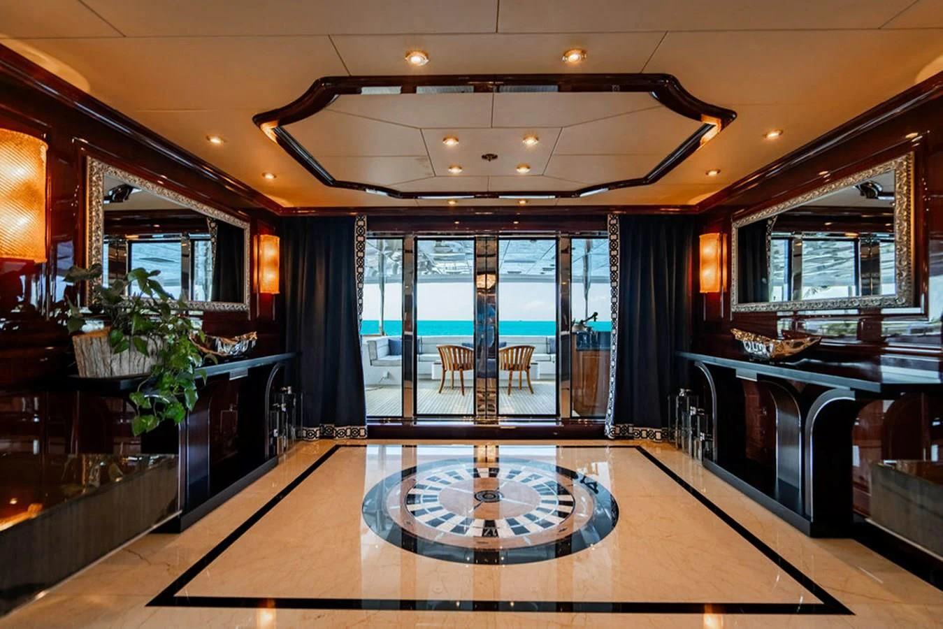 a large room with a large glass door and a large table with chairs aboard LADY ELAINE Yacht for Charter