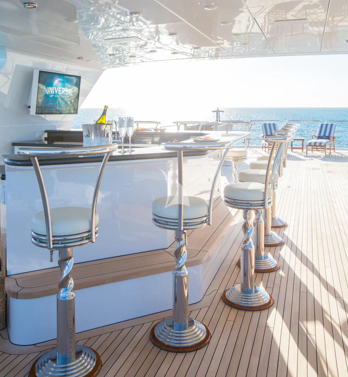 a table with chairs and a television aboard LADY ELAINE Yacht for Charter