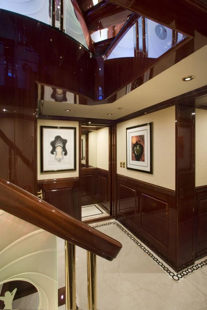 a staircase with paintings on the wall aboard LADY ELAINE Yacht for Charter