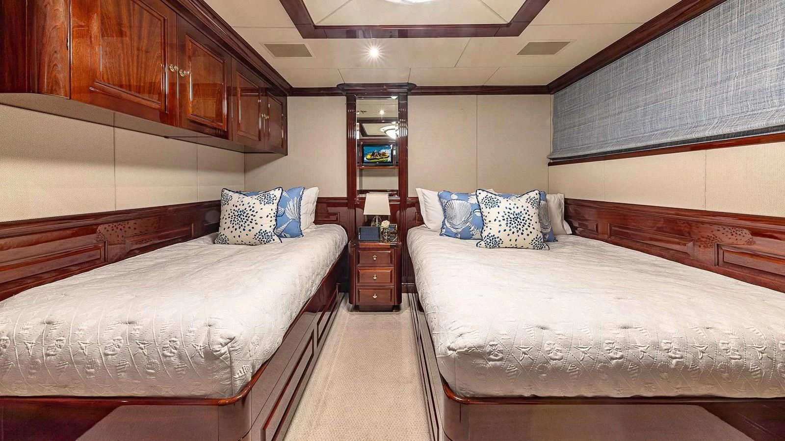 a room with beds and a tv aboard LADY ELAINE Yacht for Charter
