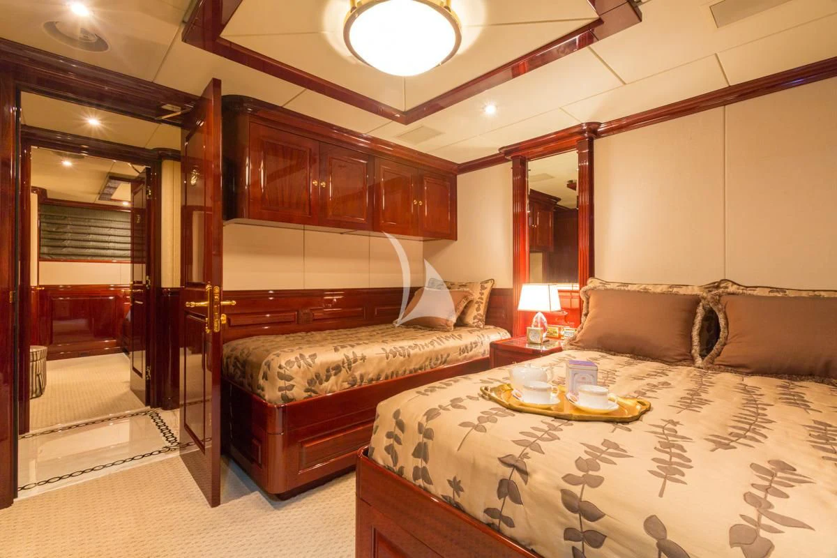 a bedroom with a bed and a mirror aboard LADY ELAINE Yacht for Charter