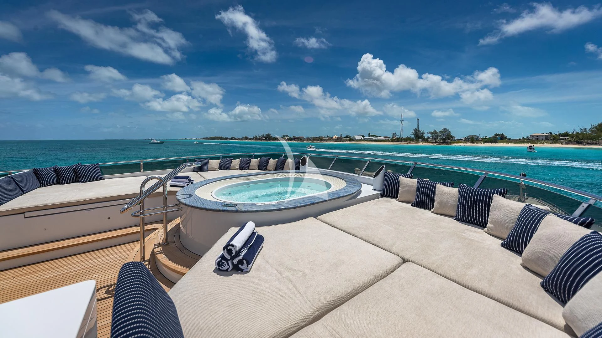 a pool on a deck overlooking a beach aboard LADY ELAINE Yacht for Charter