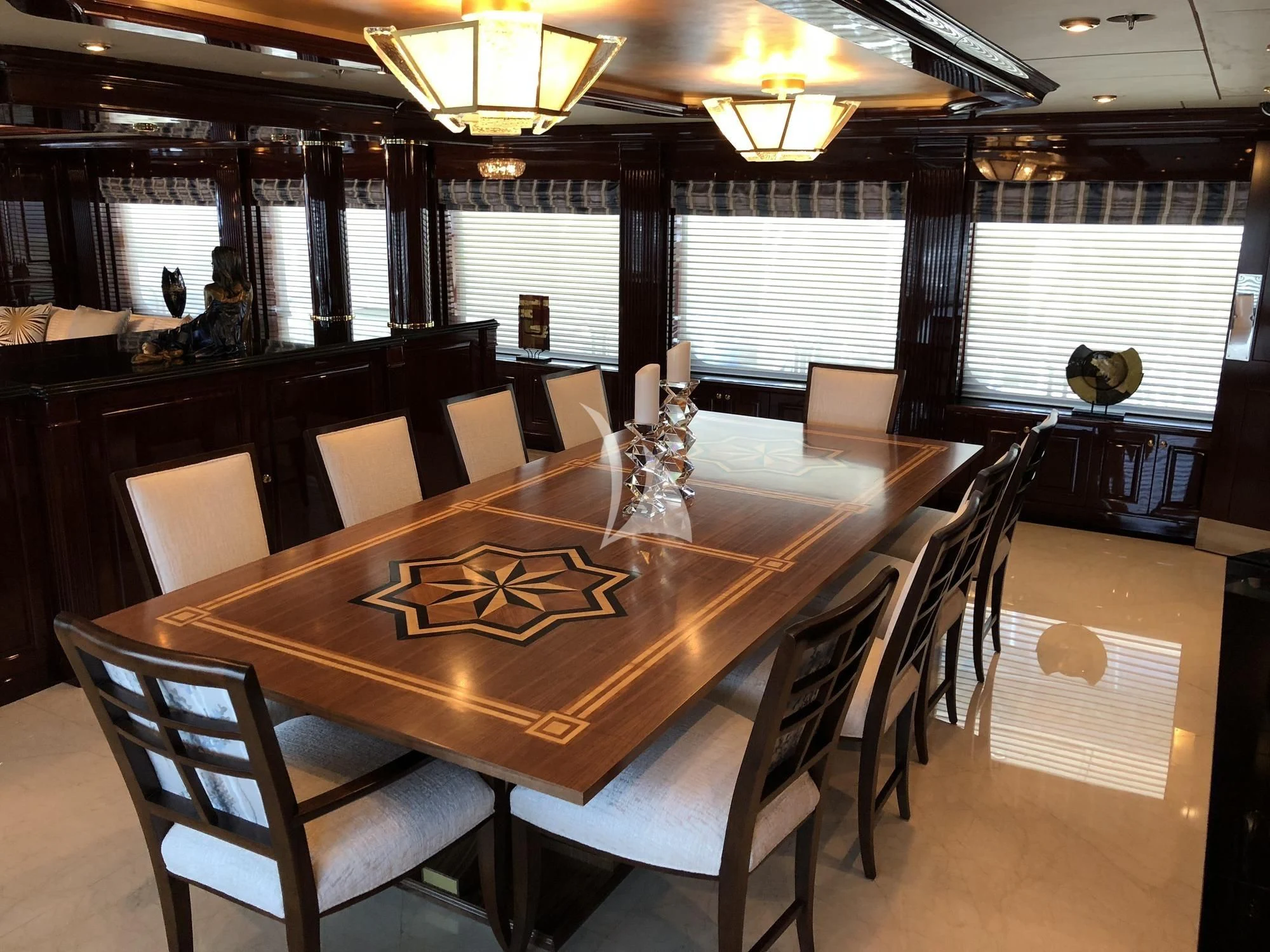 a large wooden table with chairs aboard LADY ELAINE Yacht for Charter