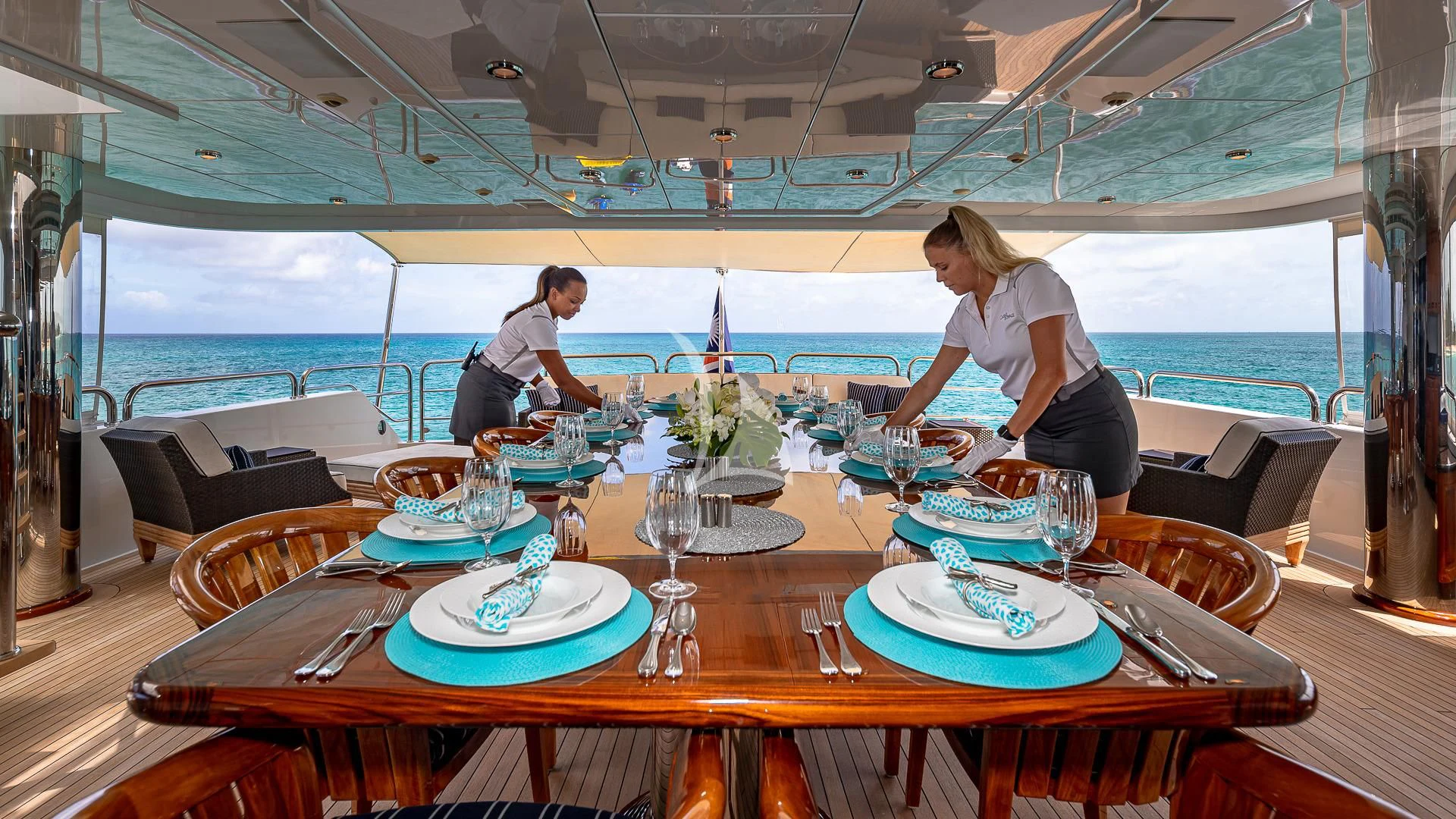 a couple of people sitting at a table with food on it aboard LADY ELAINE Yacht for Charter