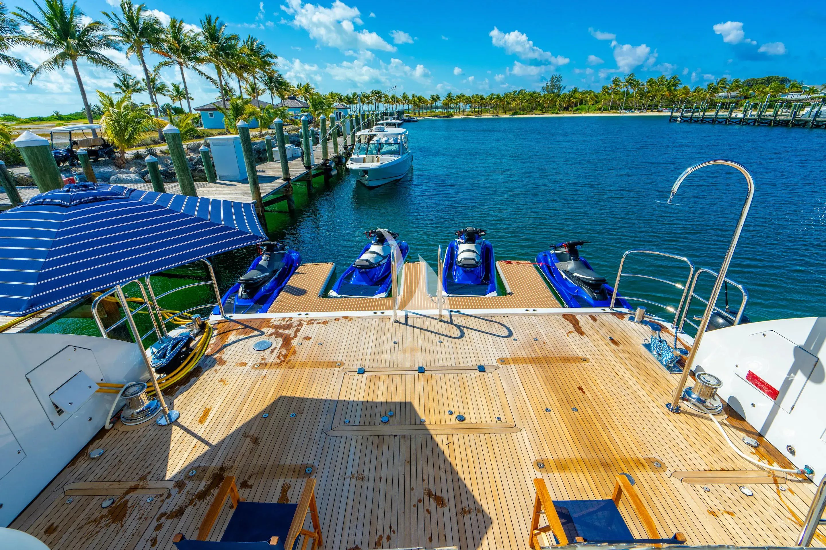 a deck with lounge chairs and boats on it aboard LADY ELAINE Yacht for Charter