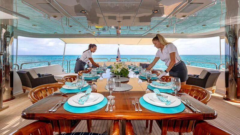 a couple of people sitting at a table with food on it aboard LADY ELAINE Yacht for Charter