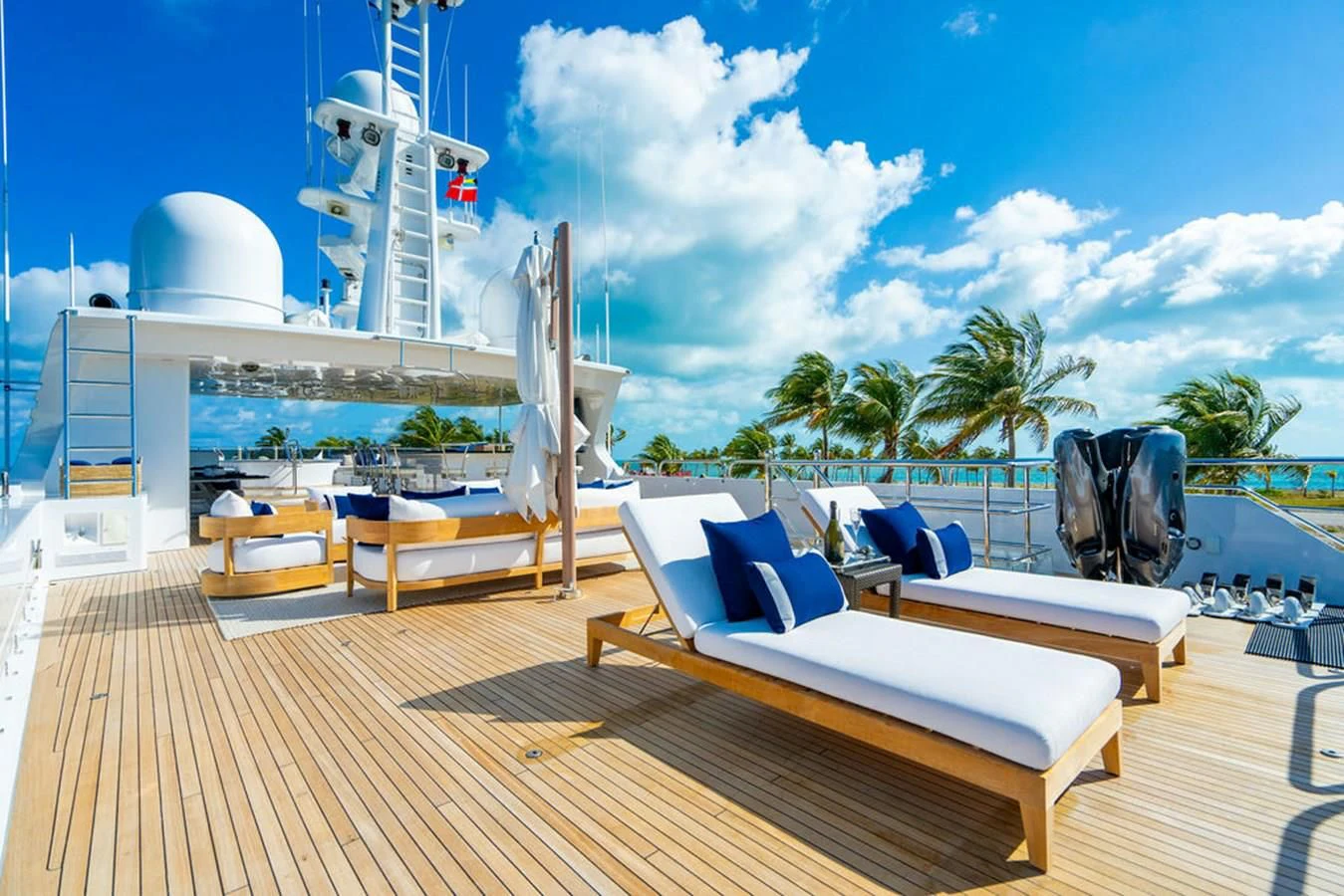 a deck with chairs and a large white tower in the background aboard LADY ELAINE Yacht for Charter
