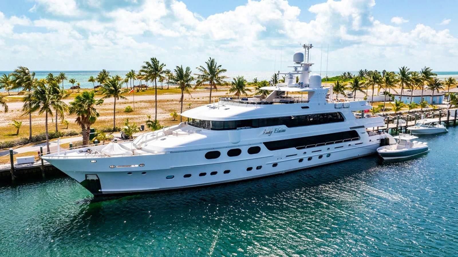 a large white yacht in a tropical setting aboard LADY ELAINE Yacht for Charter