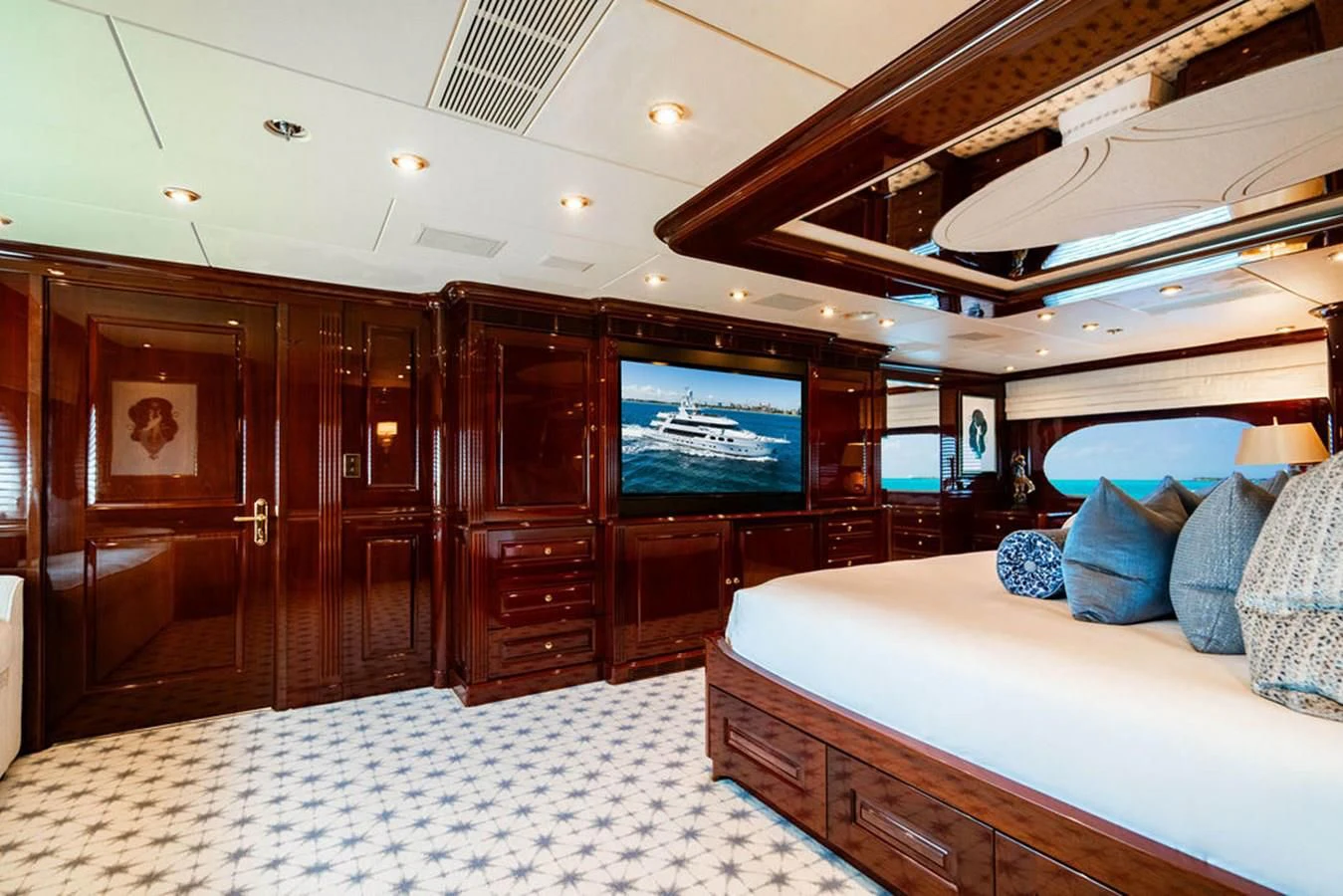 a bedroom with a bed and a television aboard LADY ELAINE Yacht for Charter