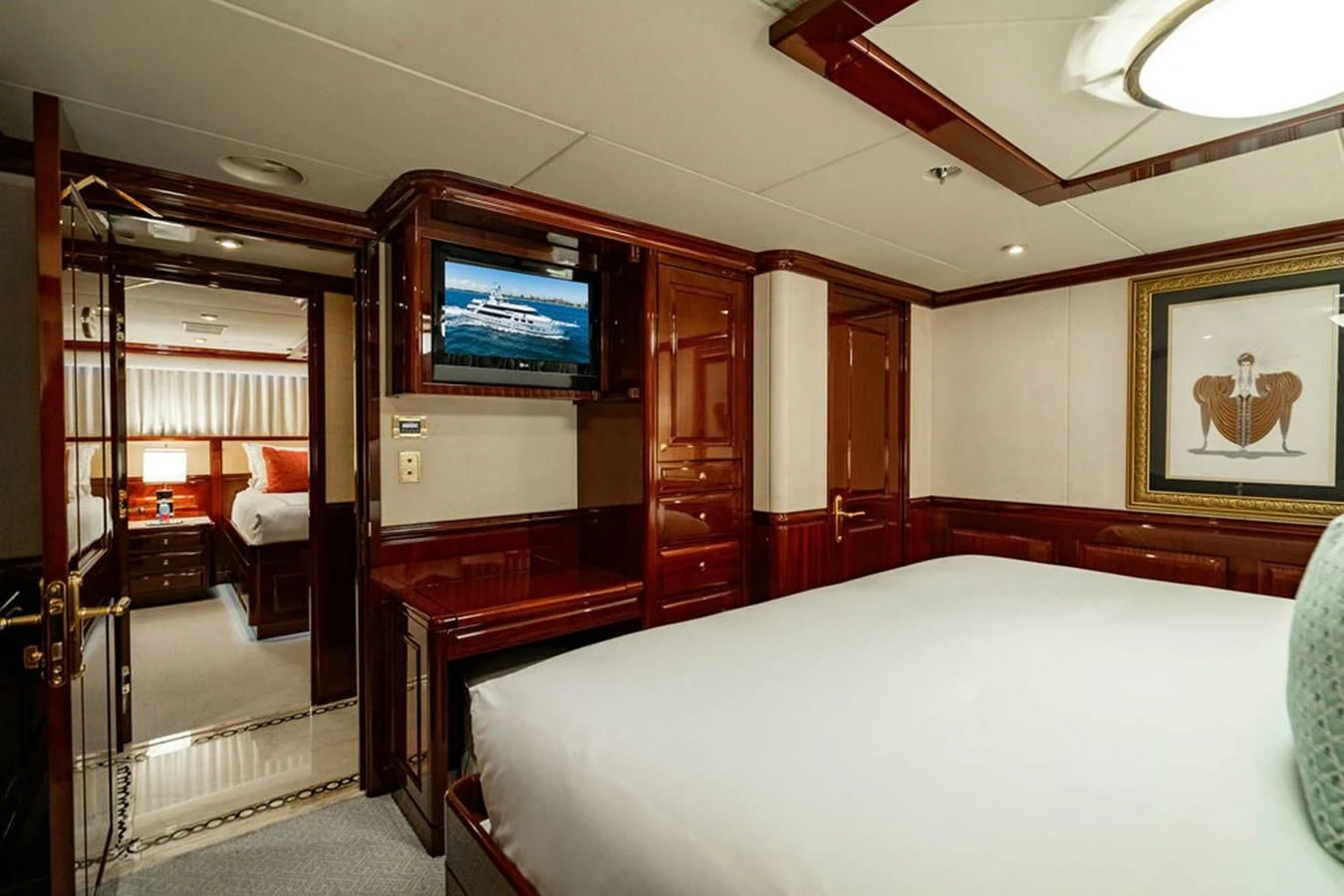 a room with a bed and a tv on the wall aboard LADY ELAINE Yacht for Charter