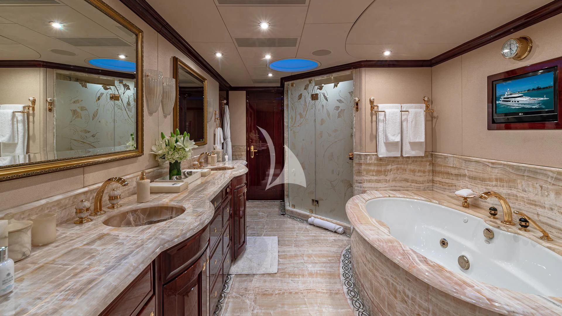 a bathroom with a bathtub sink and a mirror aboard LADY ELAINE Yacht for Charter