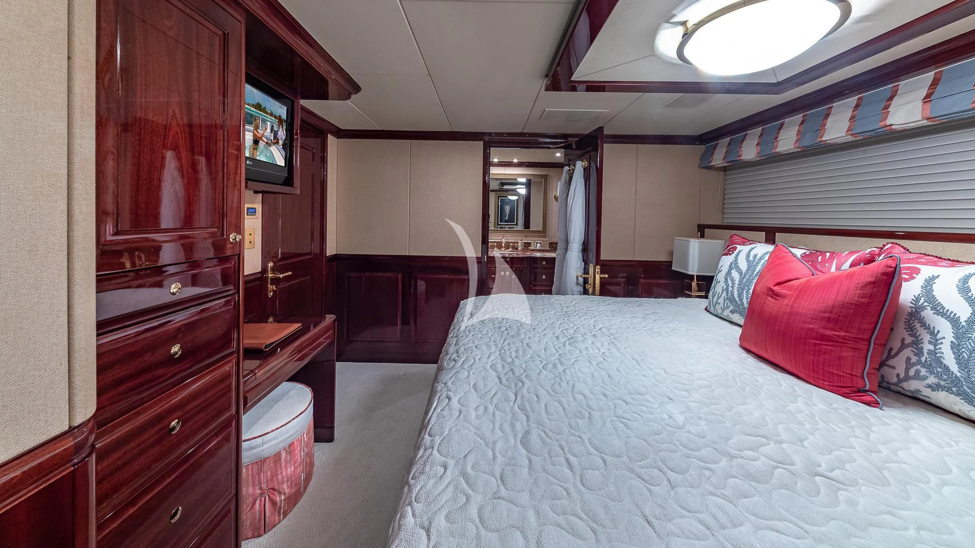 a bedroom with a bed and a television aboard LADY ELAINE Yacht for Charter