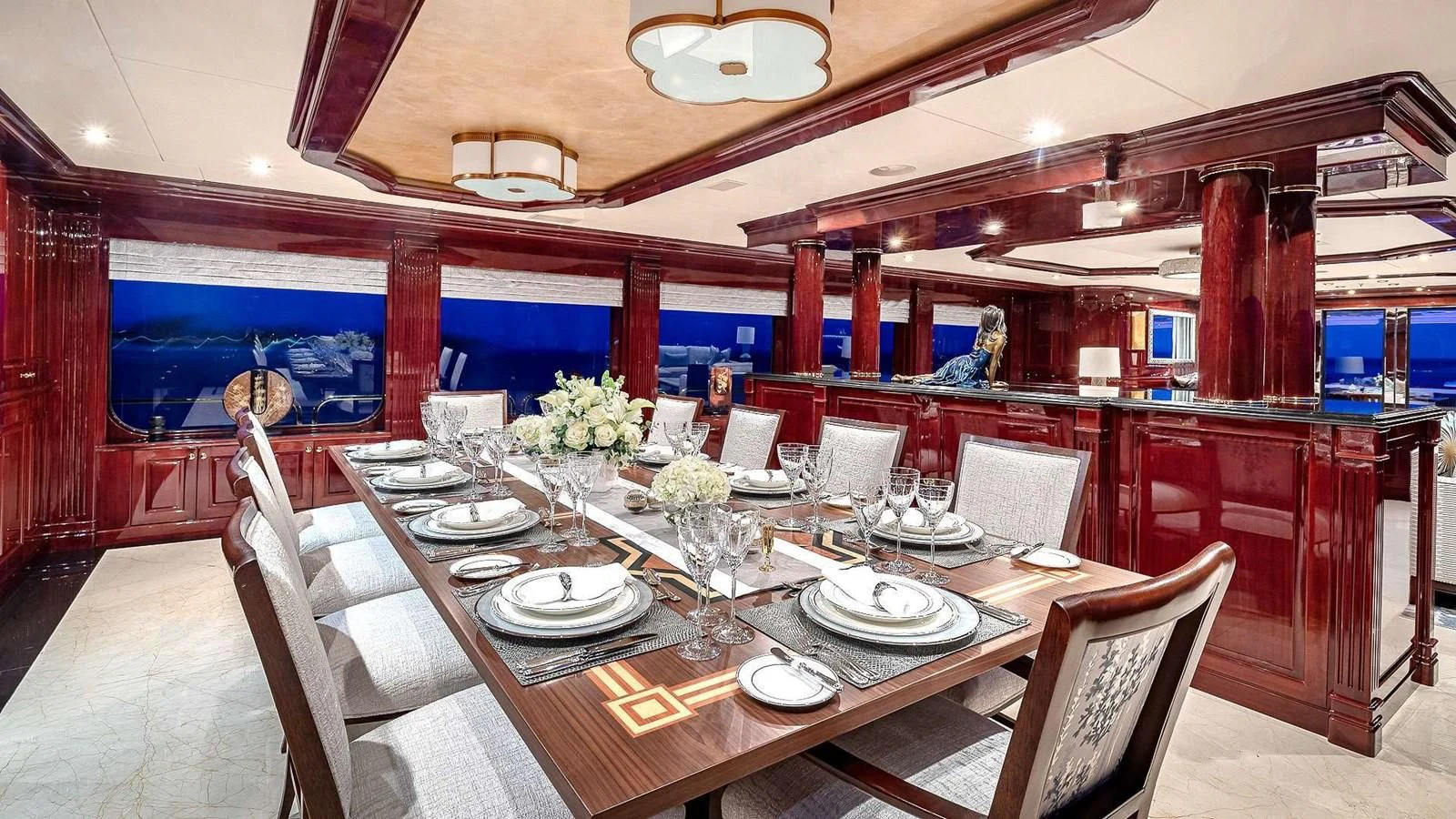 a dining room with a table set for a dinner aboard LADY ELAINE Yacht for Charter