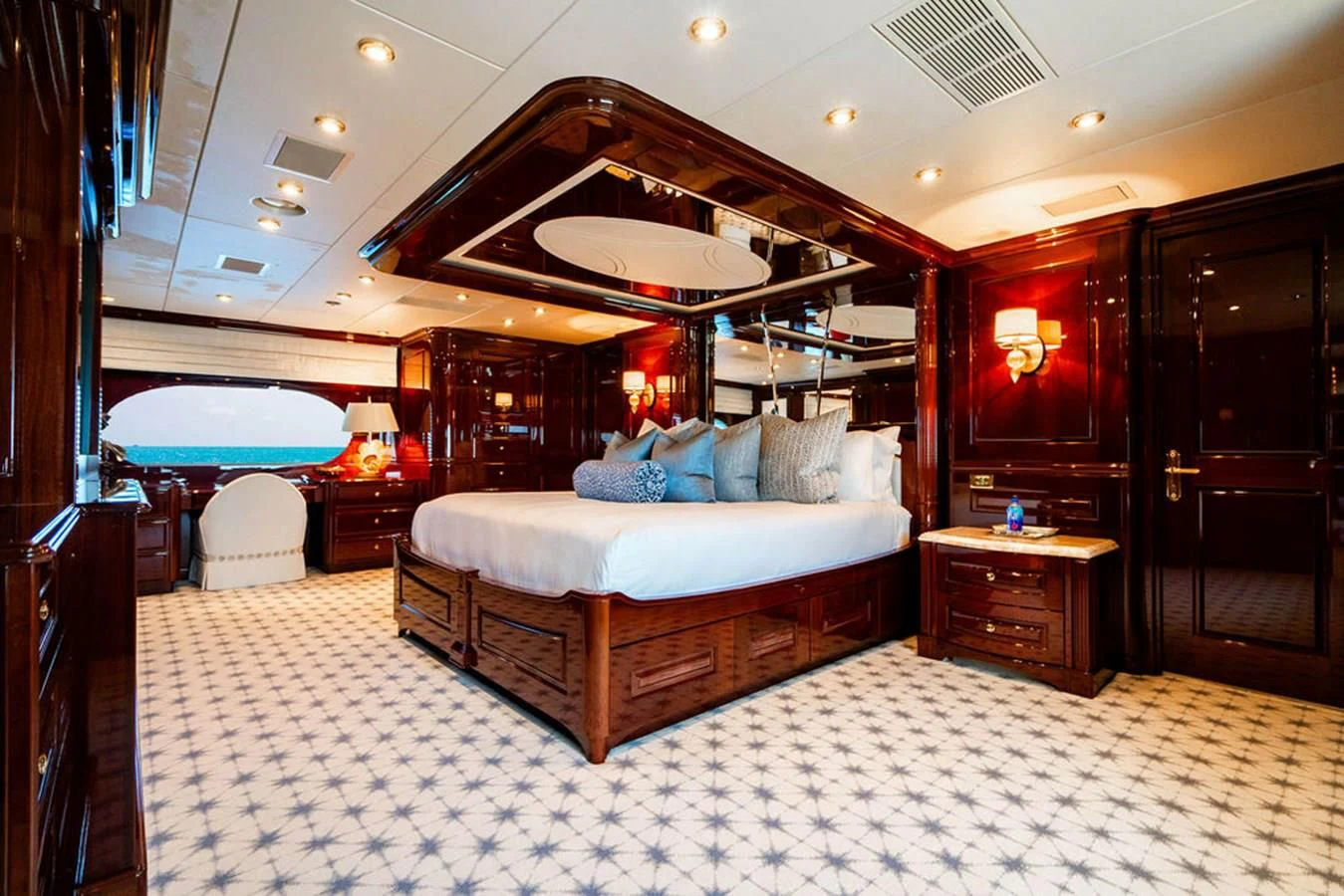 a bedroom with a bed and a large mirror aboard LADY ELAINE Yacht for Charter
