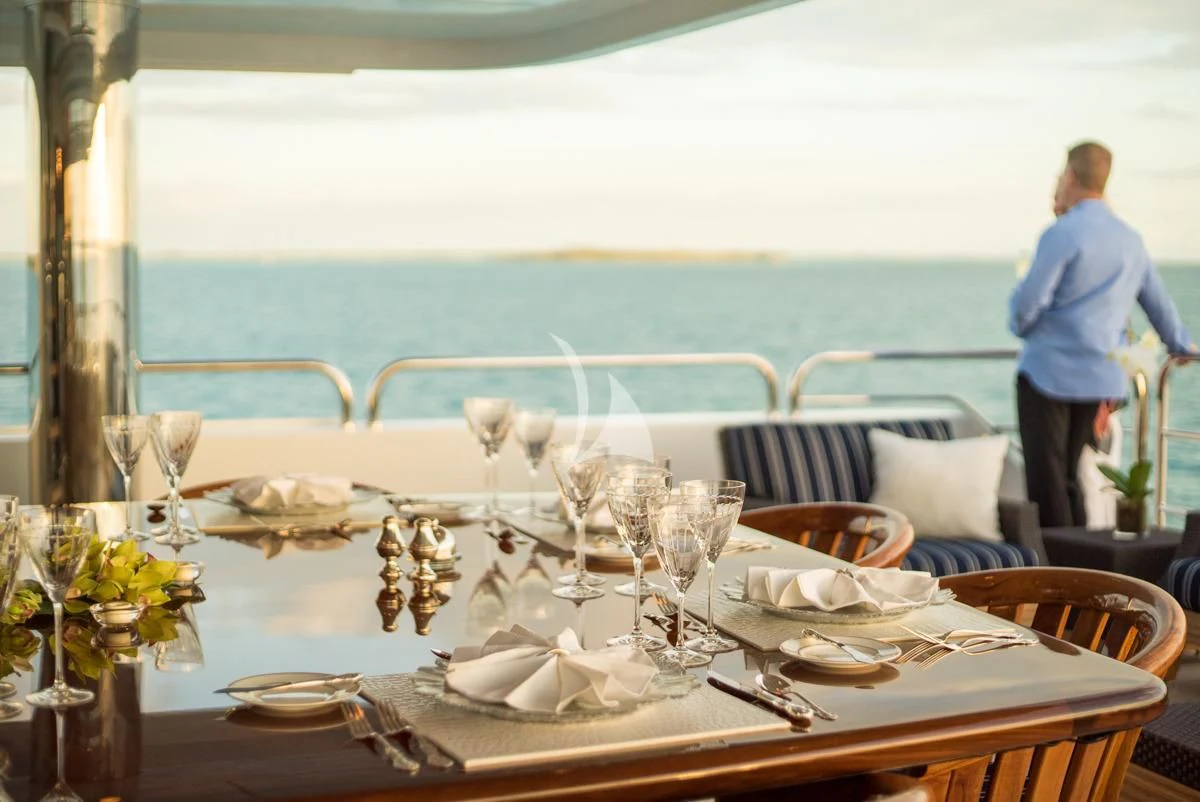 a table set with plates and glasses aboard LADY ELAINE Yacht for Charter