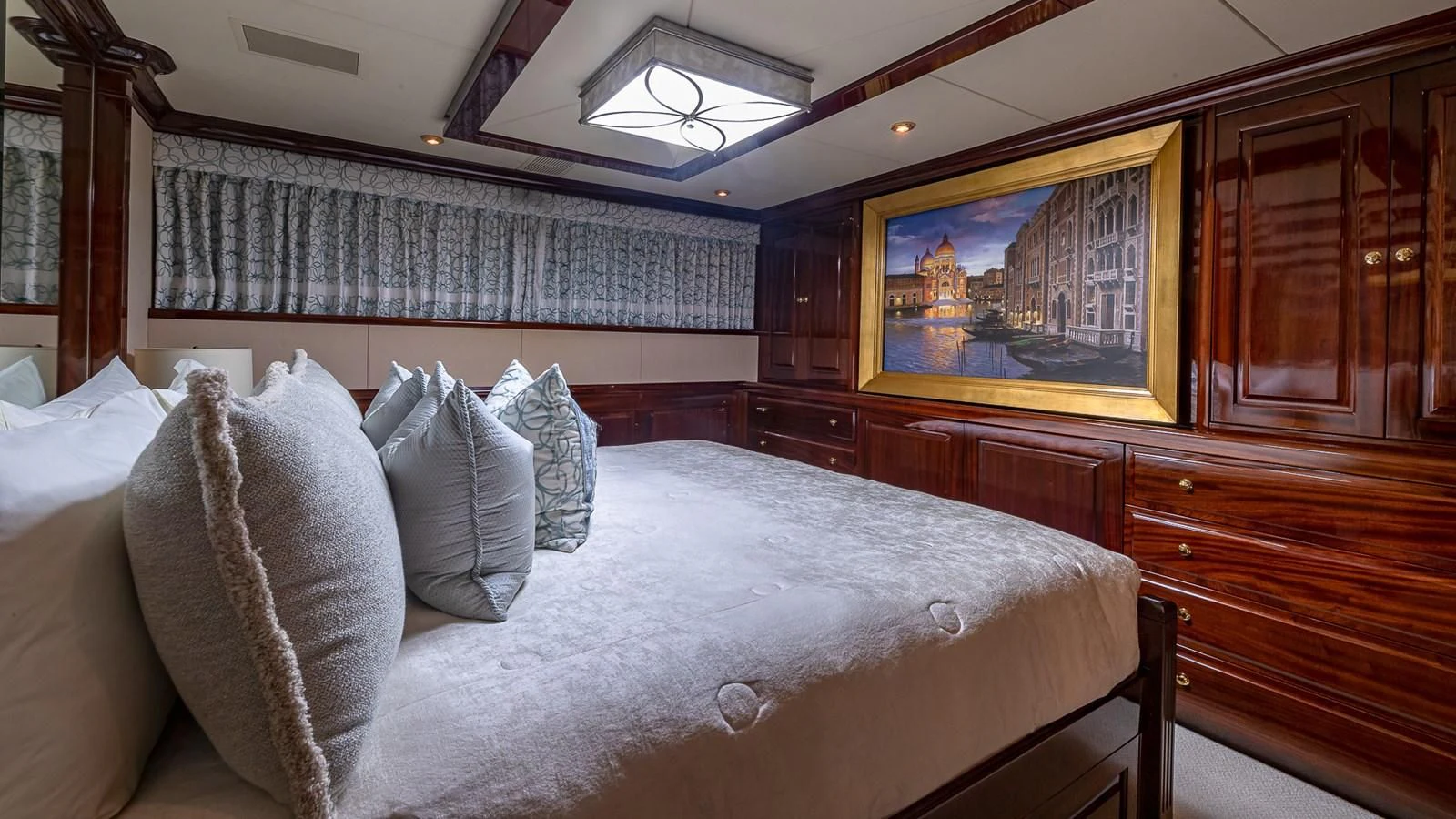 a bed with pillows and a mirror aboard LADY ELAINE Yacht for Charter