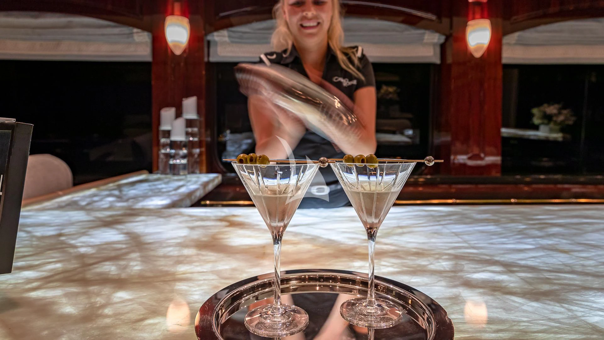 a person sitting at a table with a glass of wine aboard LADY ELAINE Yacht for Charter