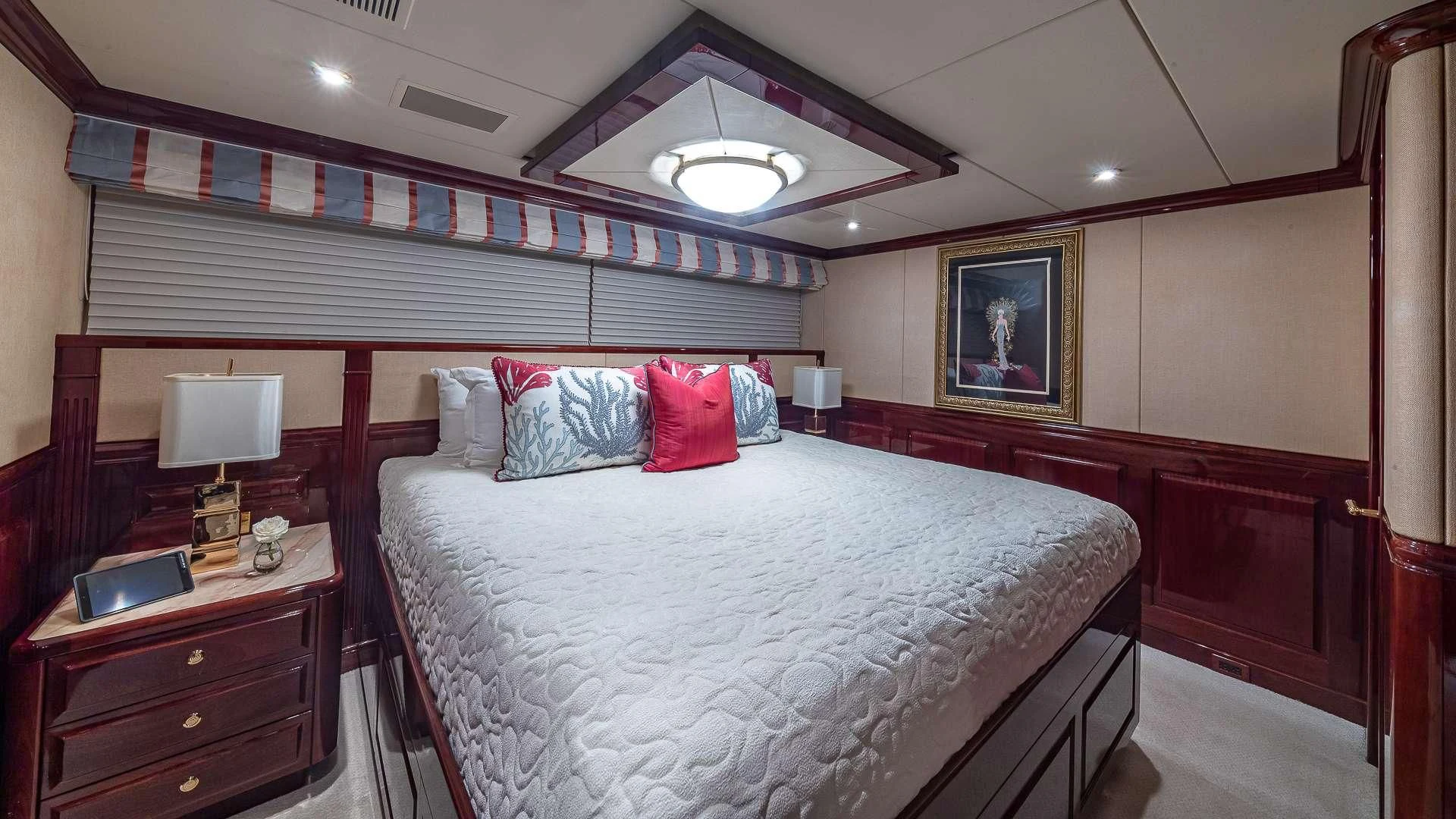 a bedroom with a bed and a desk aboard LADY ELAINE Yacht for Charter
