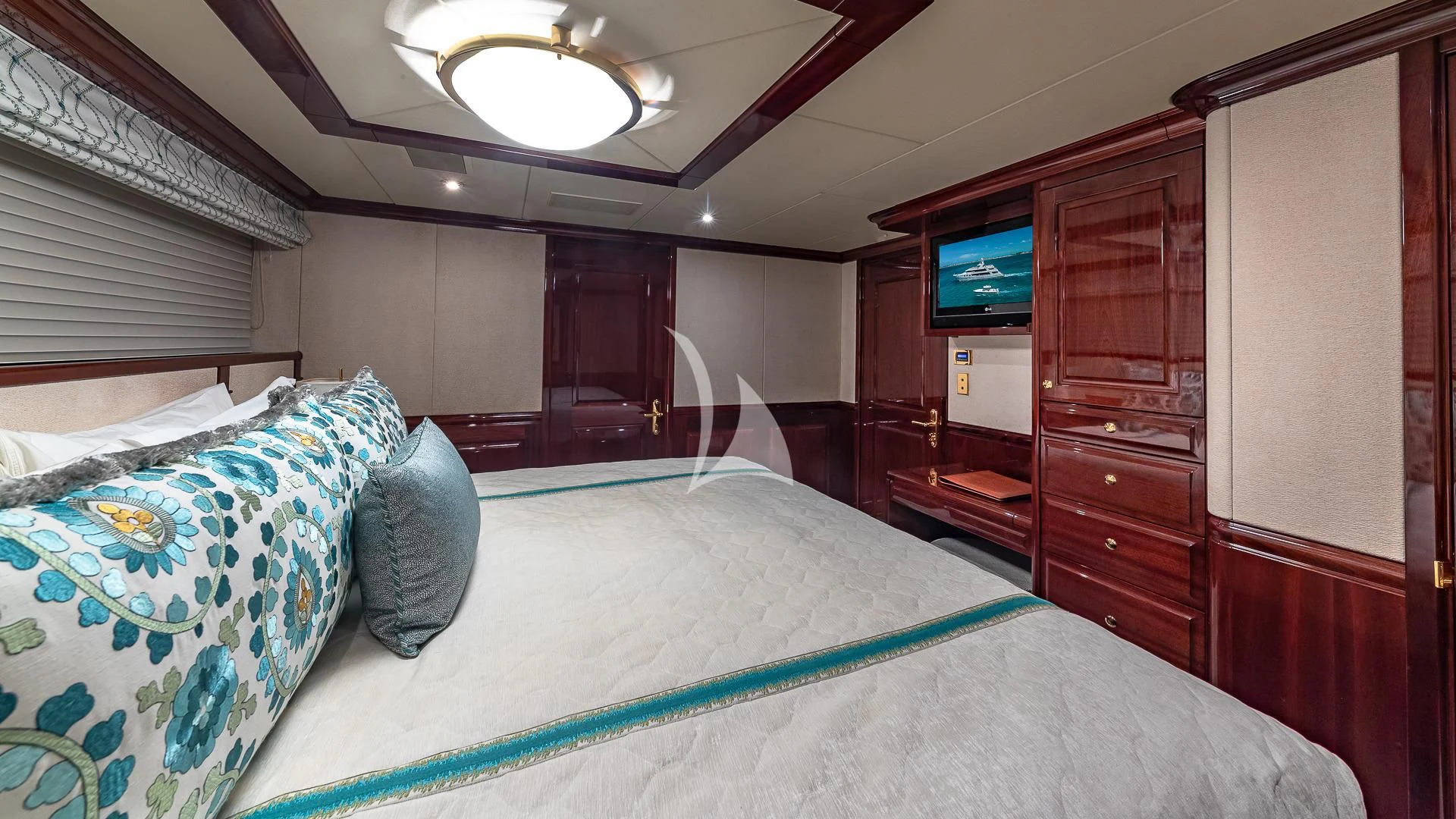 a bedroom with a bed and a television aboard LADY ELAINE Yacht for Charter
