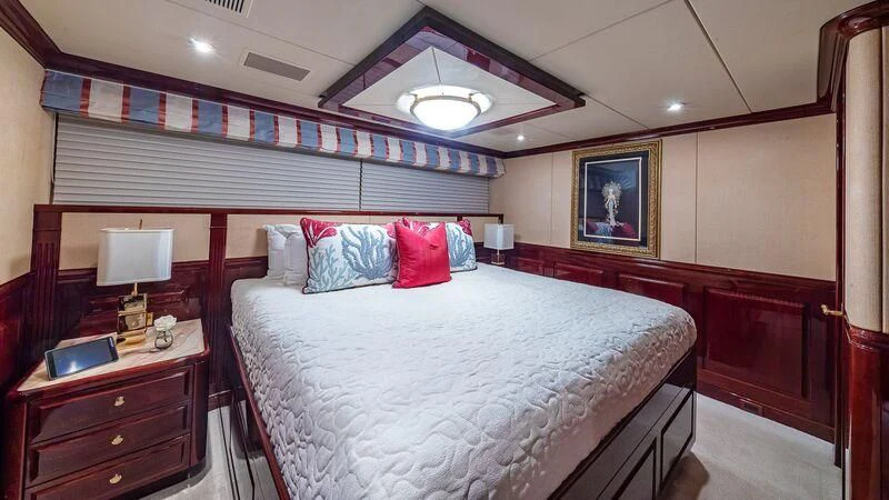 a bedroom with a bed and a desk aboard LADY ELAINE Yacht for Charter