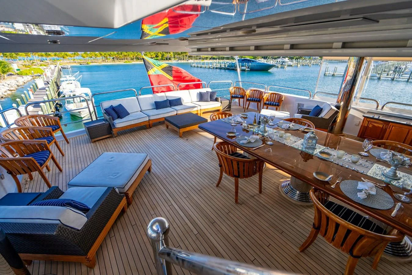 a deck with tables and chairs aboard LADY ELAINE Yacht for Charter