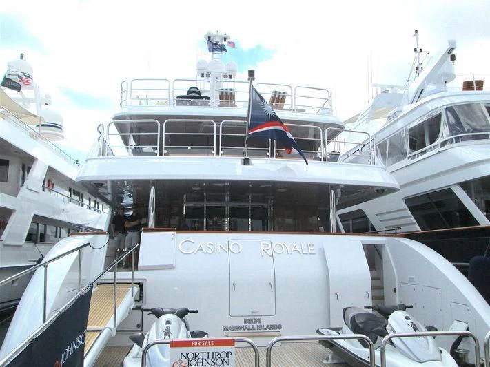 a large white boat with flags on it aboard LADY ELAINE Yacht for Charter