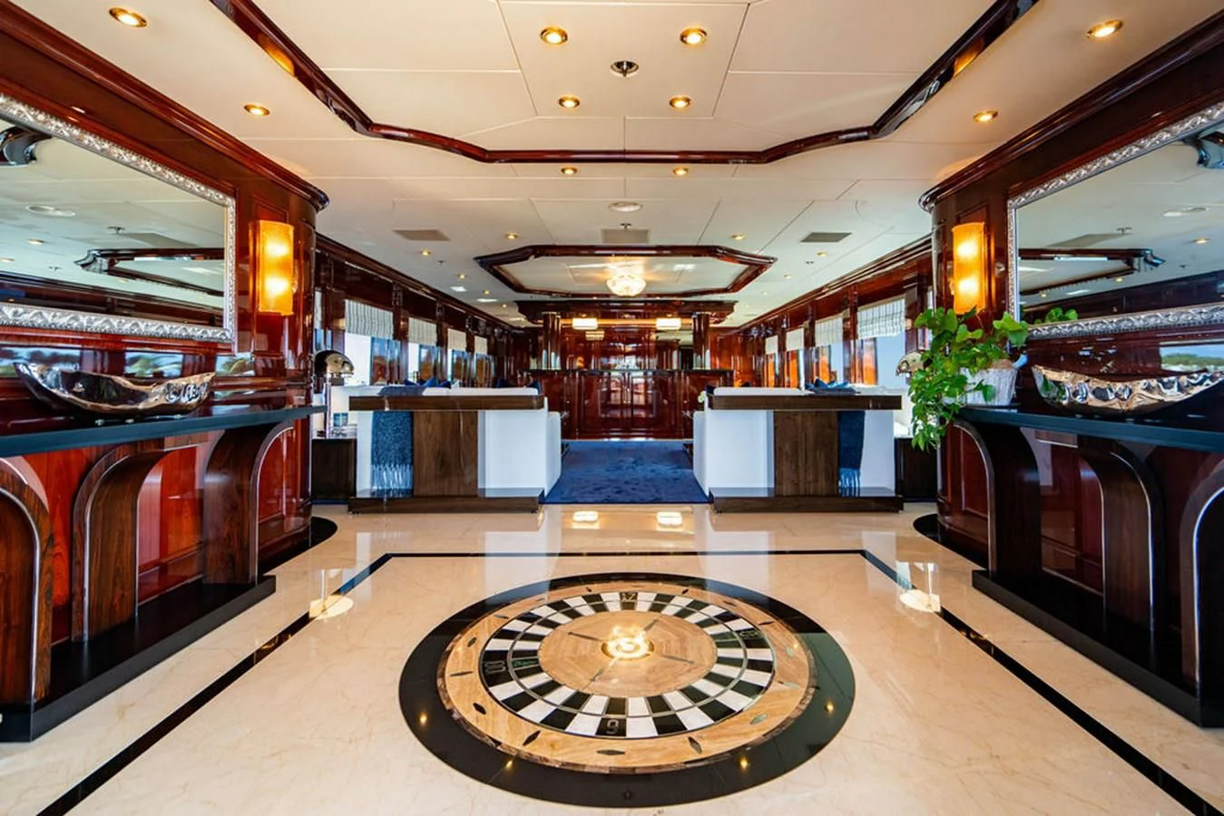 a large room with a round table and a large round rug aboard LADY ELAINE Yacht for Charter