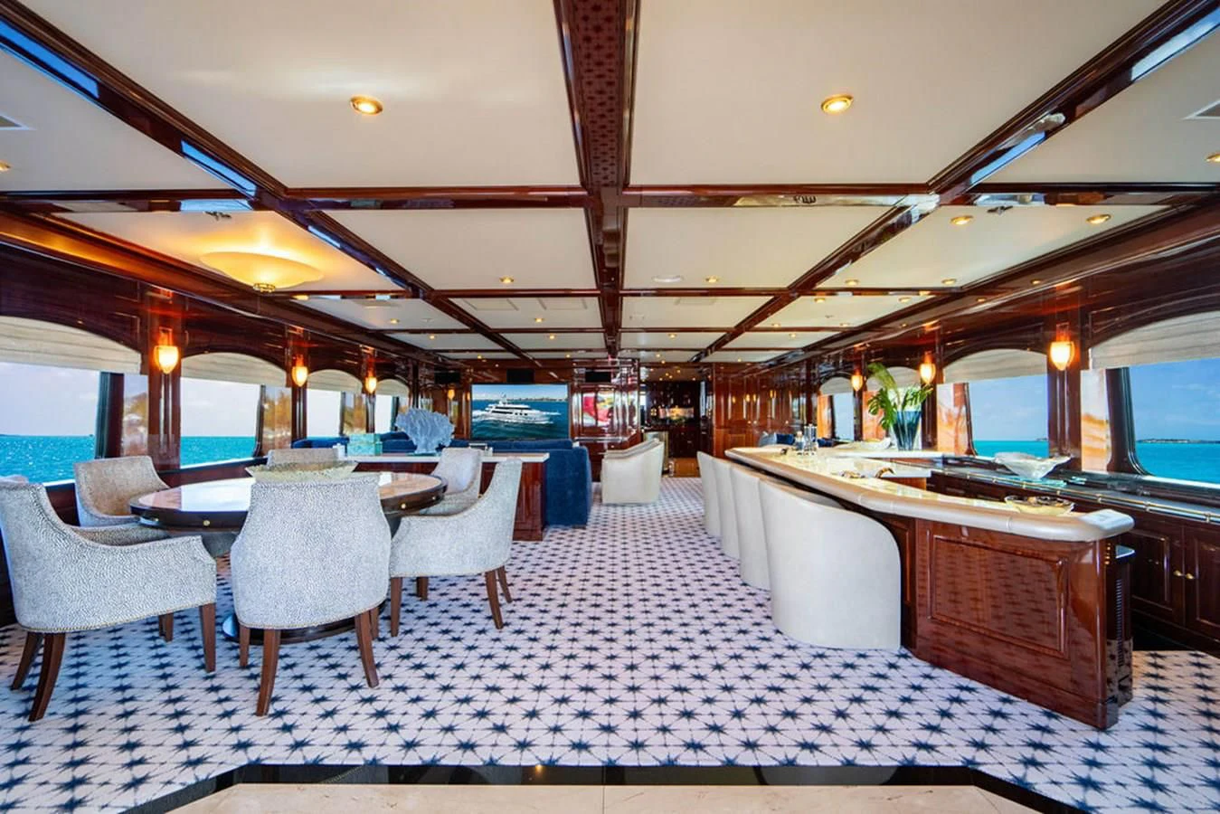 a room with a table chairs and a large window aboard LADY ELAINE Yacht for Charter