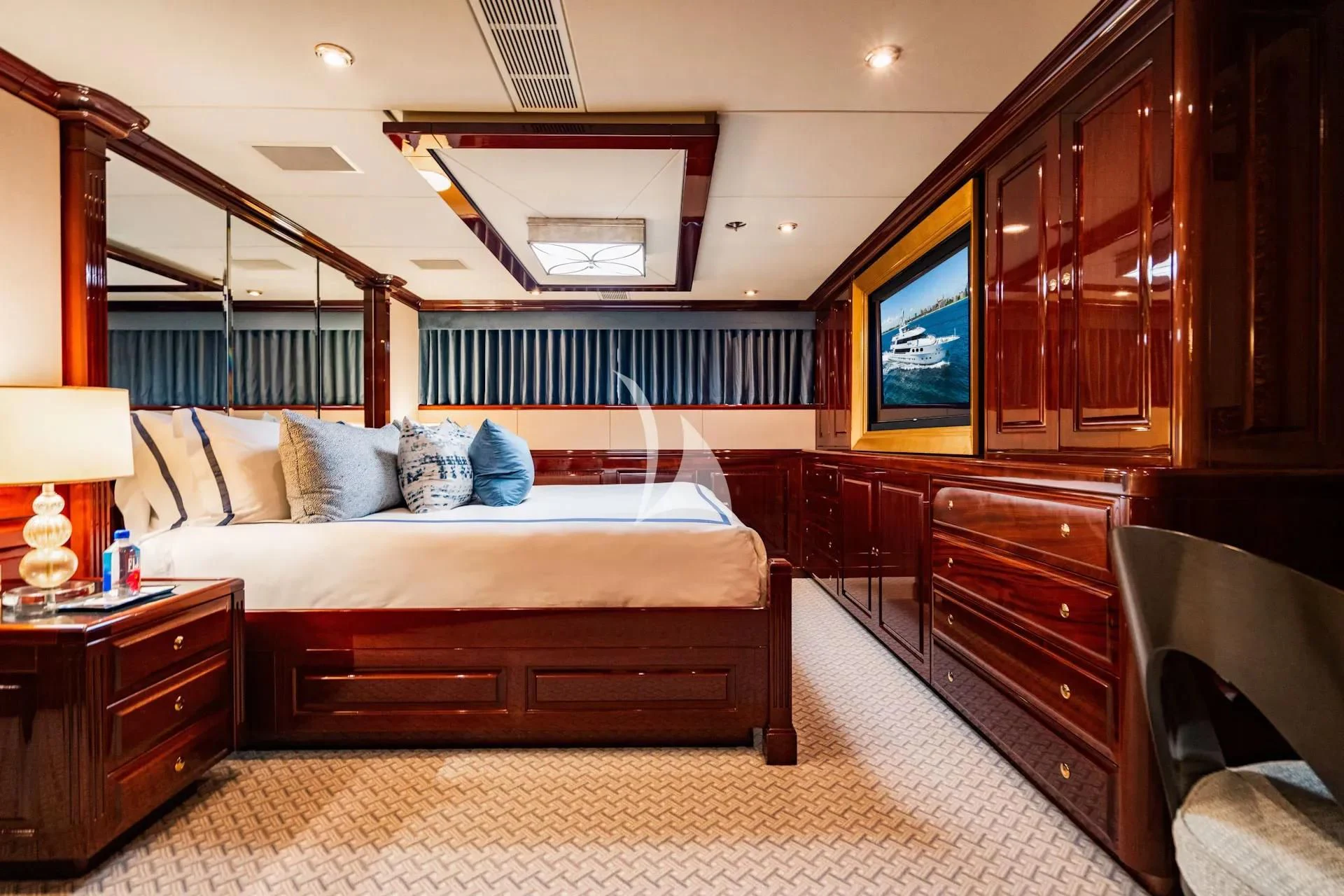 a bedroom with a bed and a tv aboard LADY ELAINE Yacht for Charter