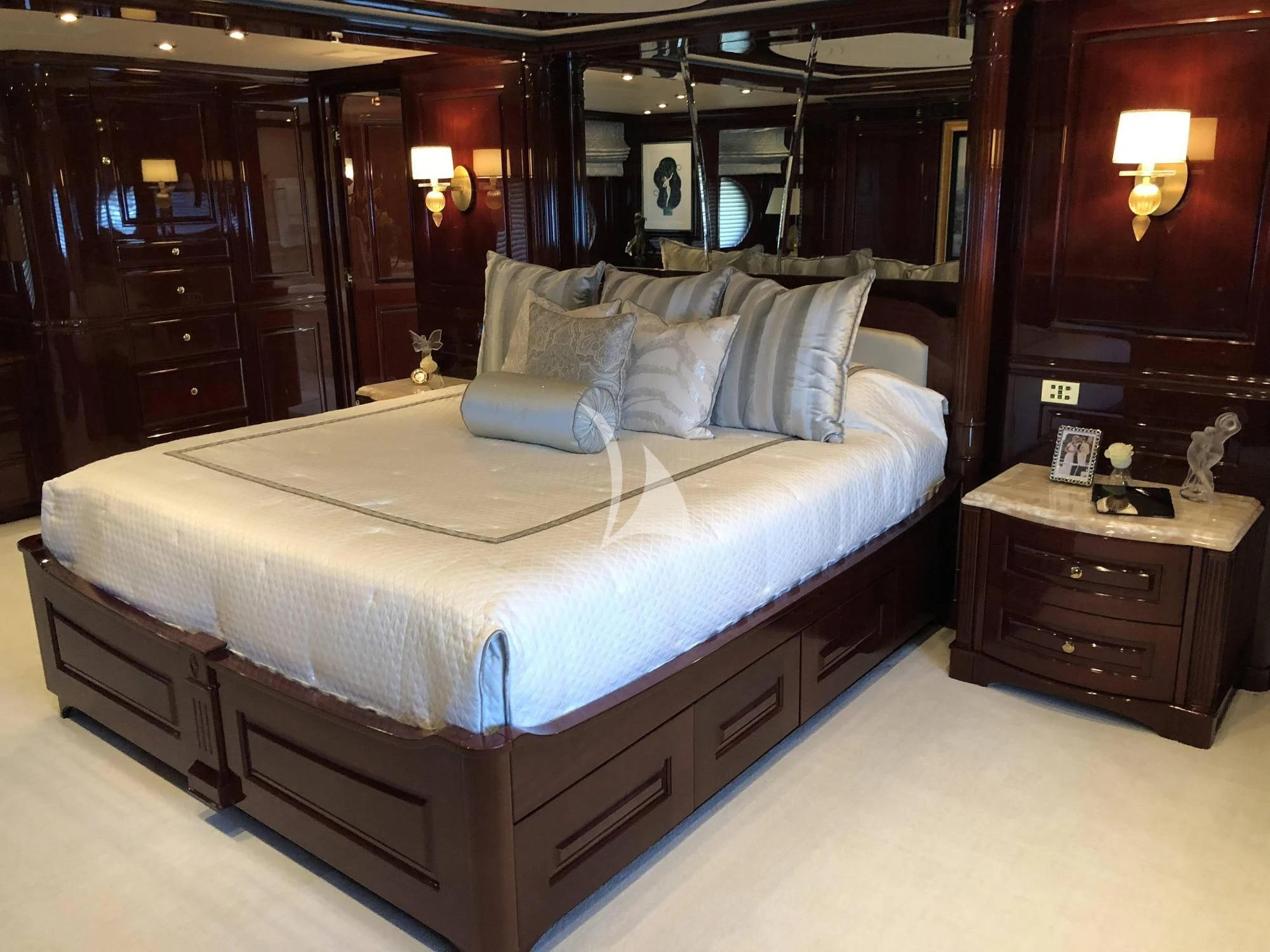 a bed with a white comforter aboard LADY ELAINE Yacht for Charter
