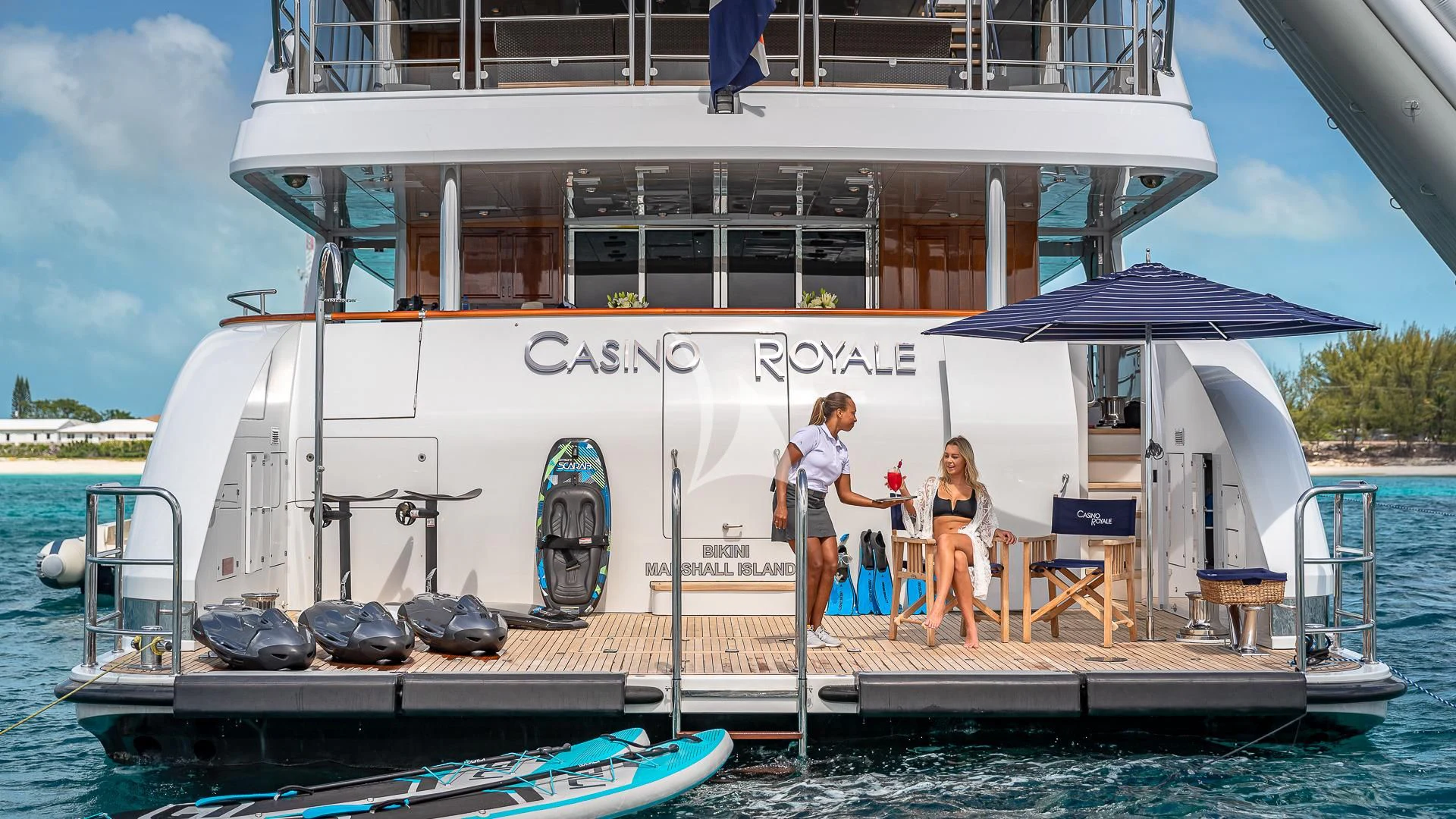 a couple of people standing on a dock next to a boat aboard LADY ELAINE Yacht for Charter
