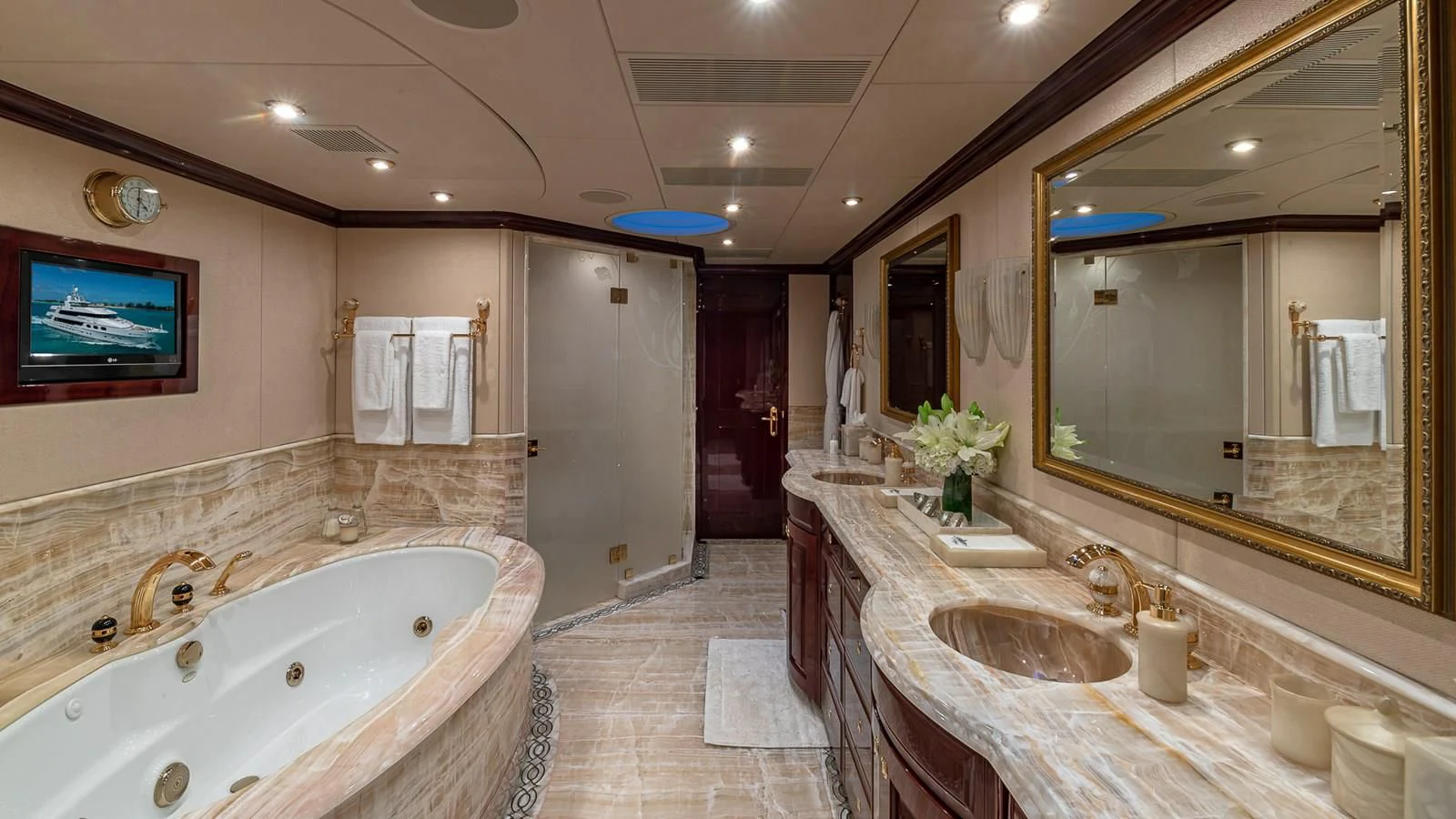 a bathroom with a large bathtub and sinks aboard LADY ELAINE Yacht for Charter